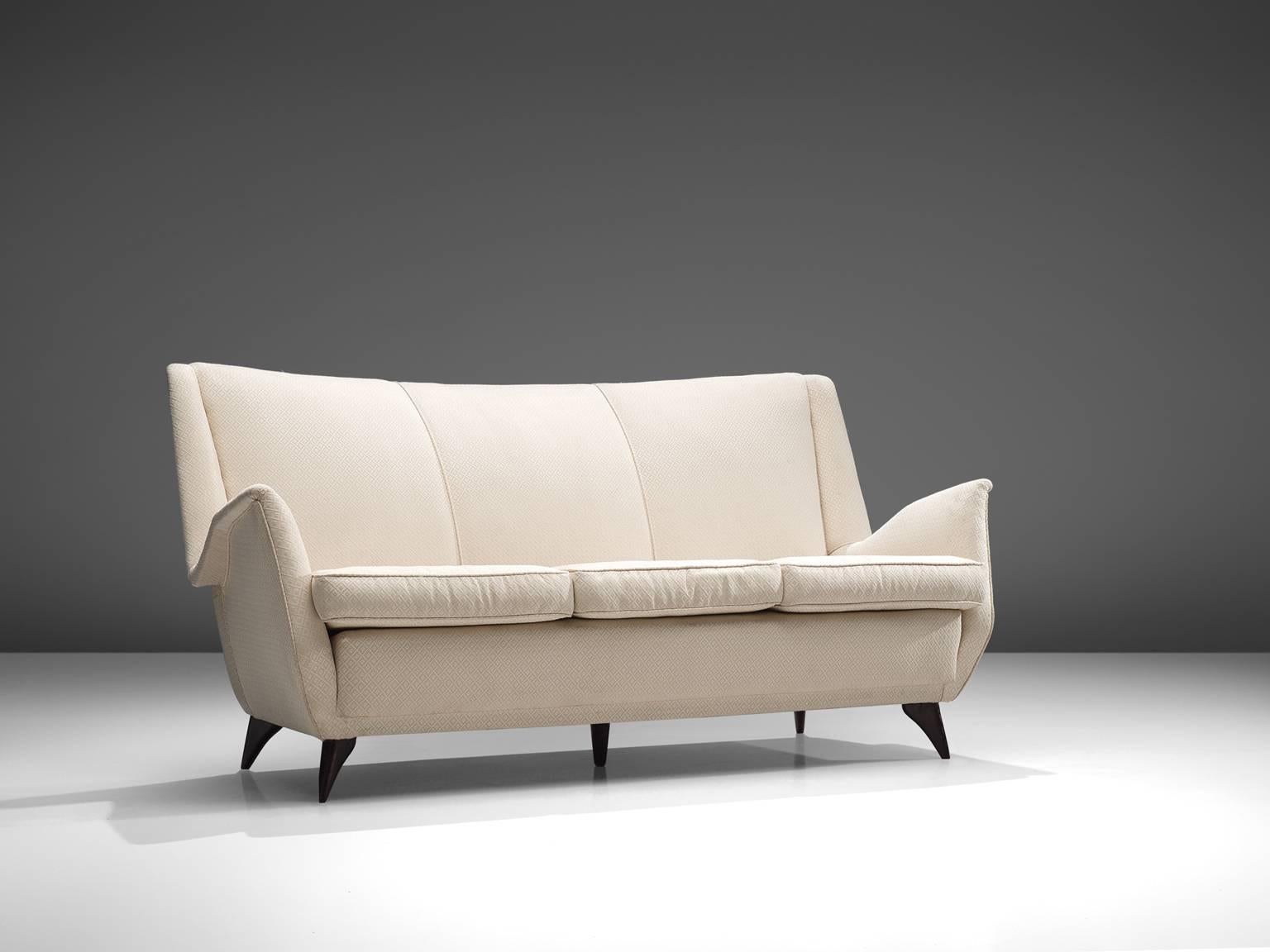 Sofa, wood and white fabric, Italy, 1950s.

Three-seat Italian sofa in off-white pattern fabric. This sofa shows beautiful and elegant lines. The wide seating is accomplished with nicely pointed armrests that give this settee an airy, frivolous
