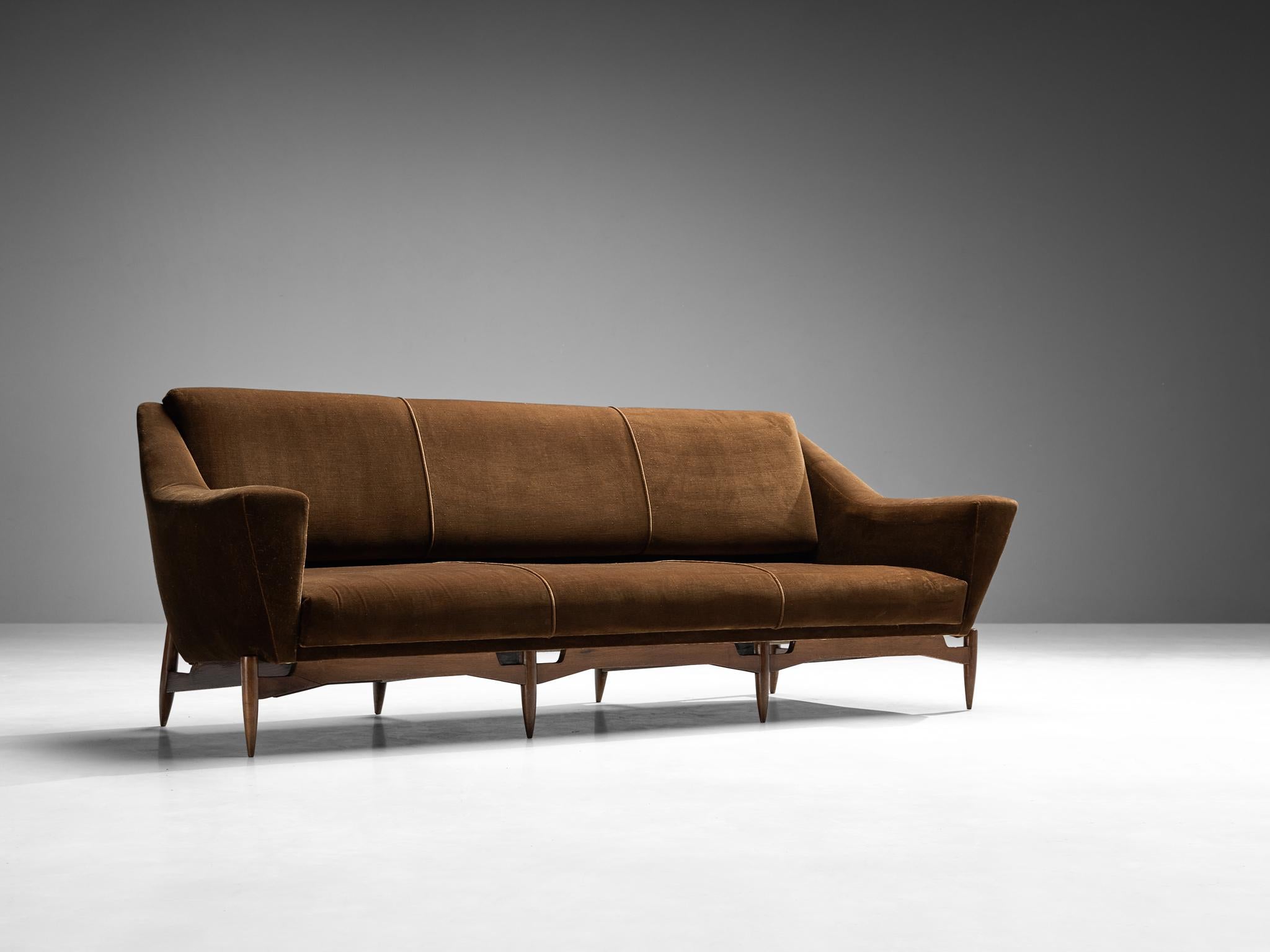 Sofa, brown velvet, stained beech, Italy, 1950s.

An extremely elegant and flattering three seat sofa, made in Italy in the 1950s. This sofa instantly reminds of the work of some prominent Italian designers that were active in that period, like