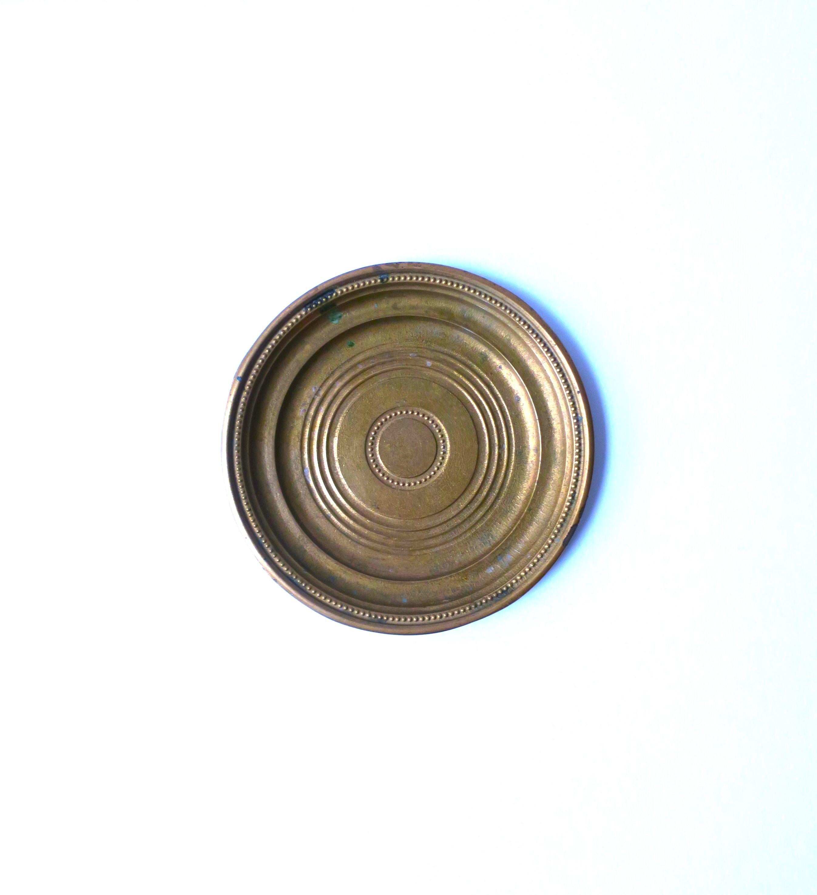 An Italian solid brass catchall vide-poche dish with bead or tiny ball design at center and around edge, circa early-20th century, Italy. A great piece for a desk, vanity, nightstand table, etc., to hold small items such as coin change, paperclips,