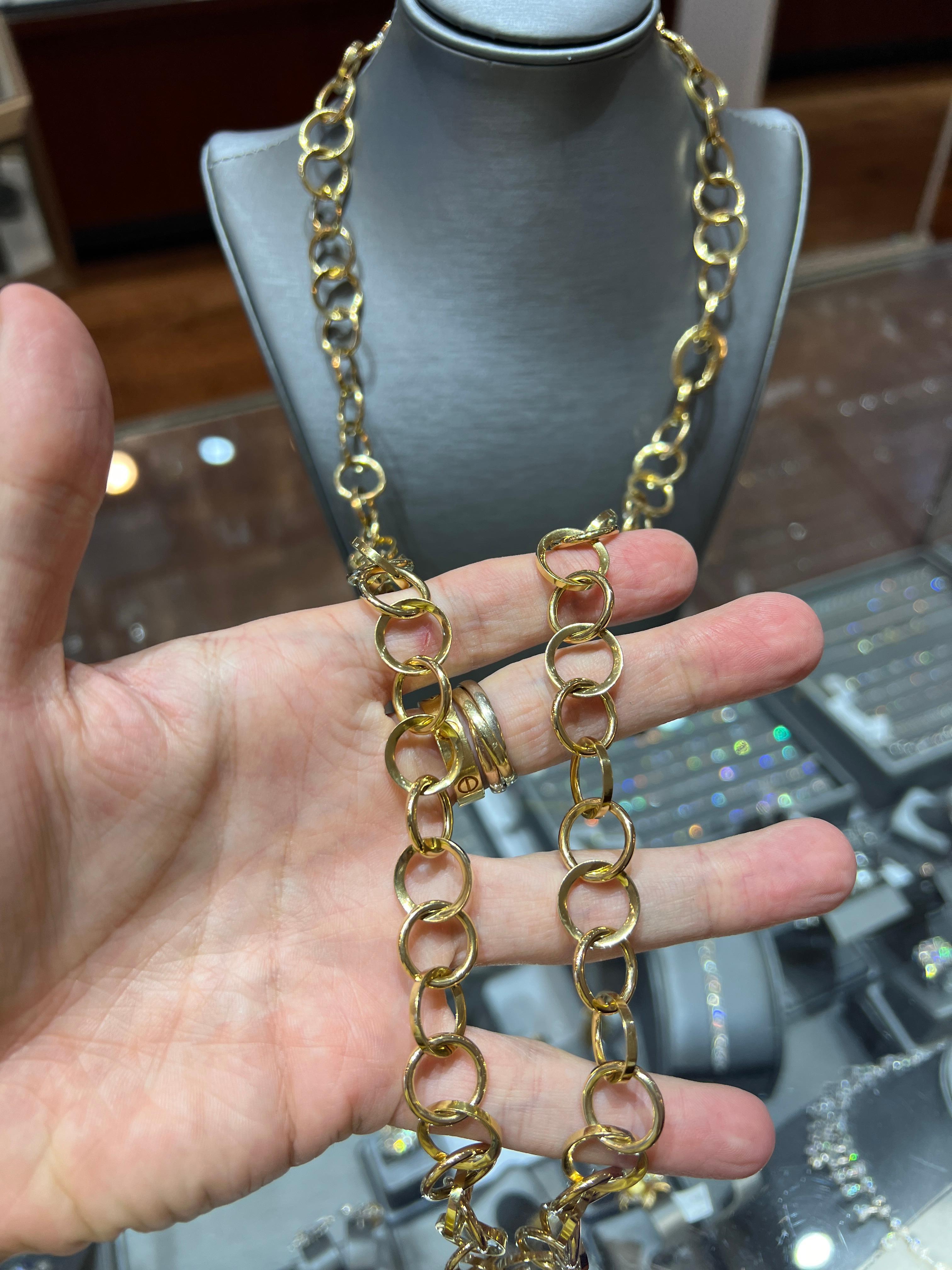A bold gold chunky and versatile 36-inch Italian link chain necklace crafted in luxurious 18K yellow gold weighing an impressive 60.0 grams. This striking piece features oversized circular links with a hidden clasp, allowing it to be worn long,