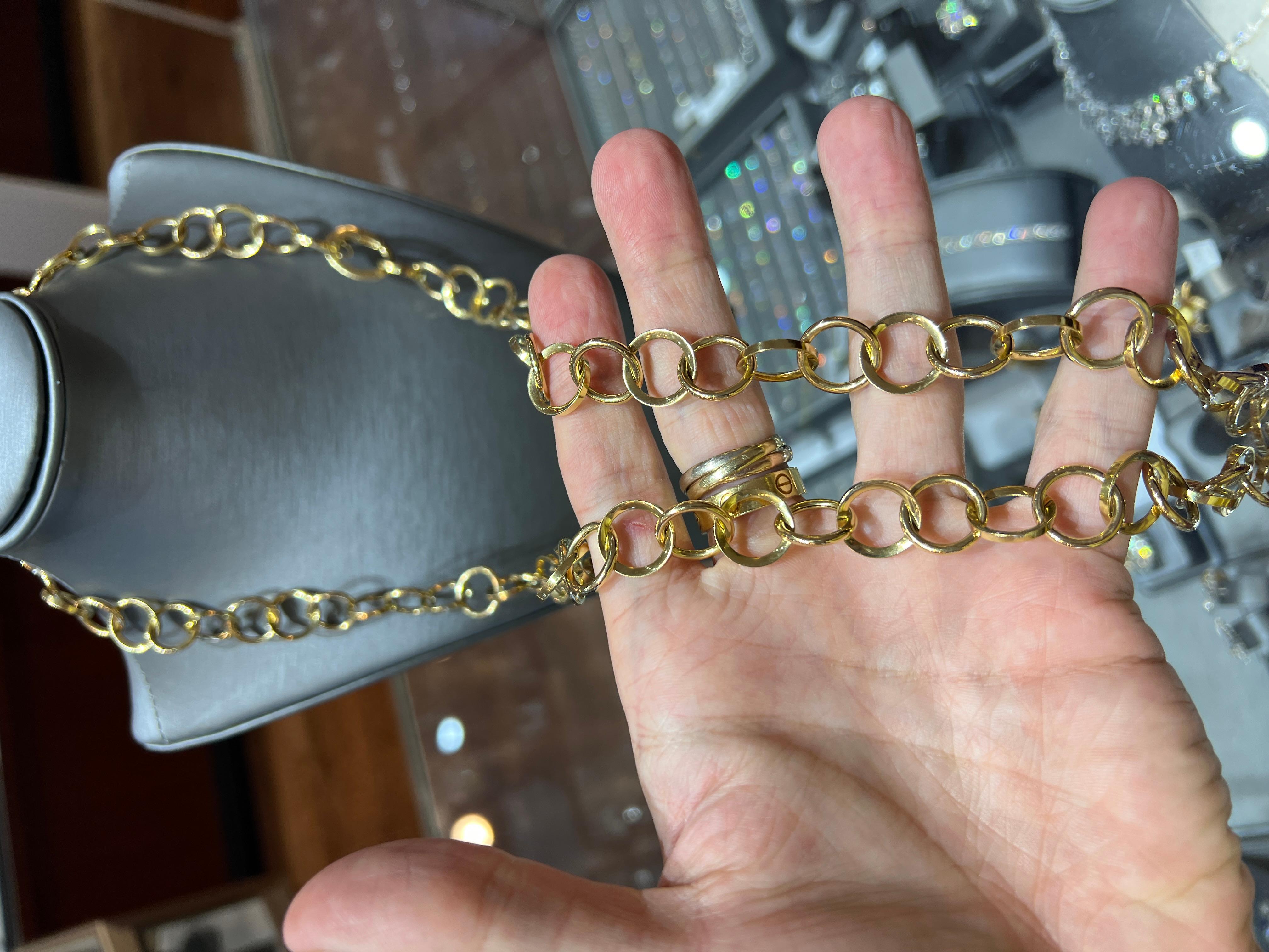 A bold gold chunky and versatile 36-inch Italian link chain necklace crafted in luxurious 18K yellow gold weighing an impressive 60.0 grams. This striking piece features oversized circular links with a hidden clasp, allowing it to be worn long,