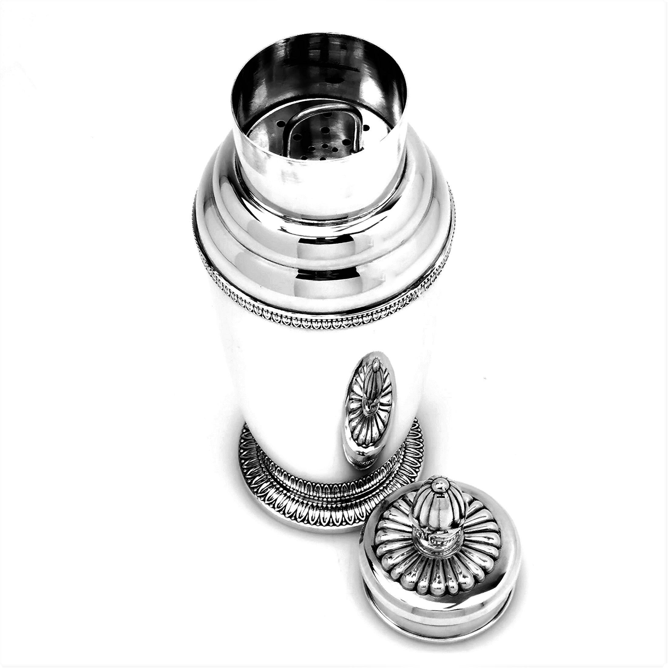 A gorgeous Italian vintage Solid Silver Cocktail Shaker with a plain polished body and embellished with a stylized leaf border on the spread foot and the shoulder. The lid has a decorative chased finial with a fluted pattern around the base.

Made