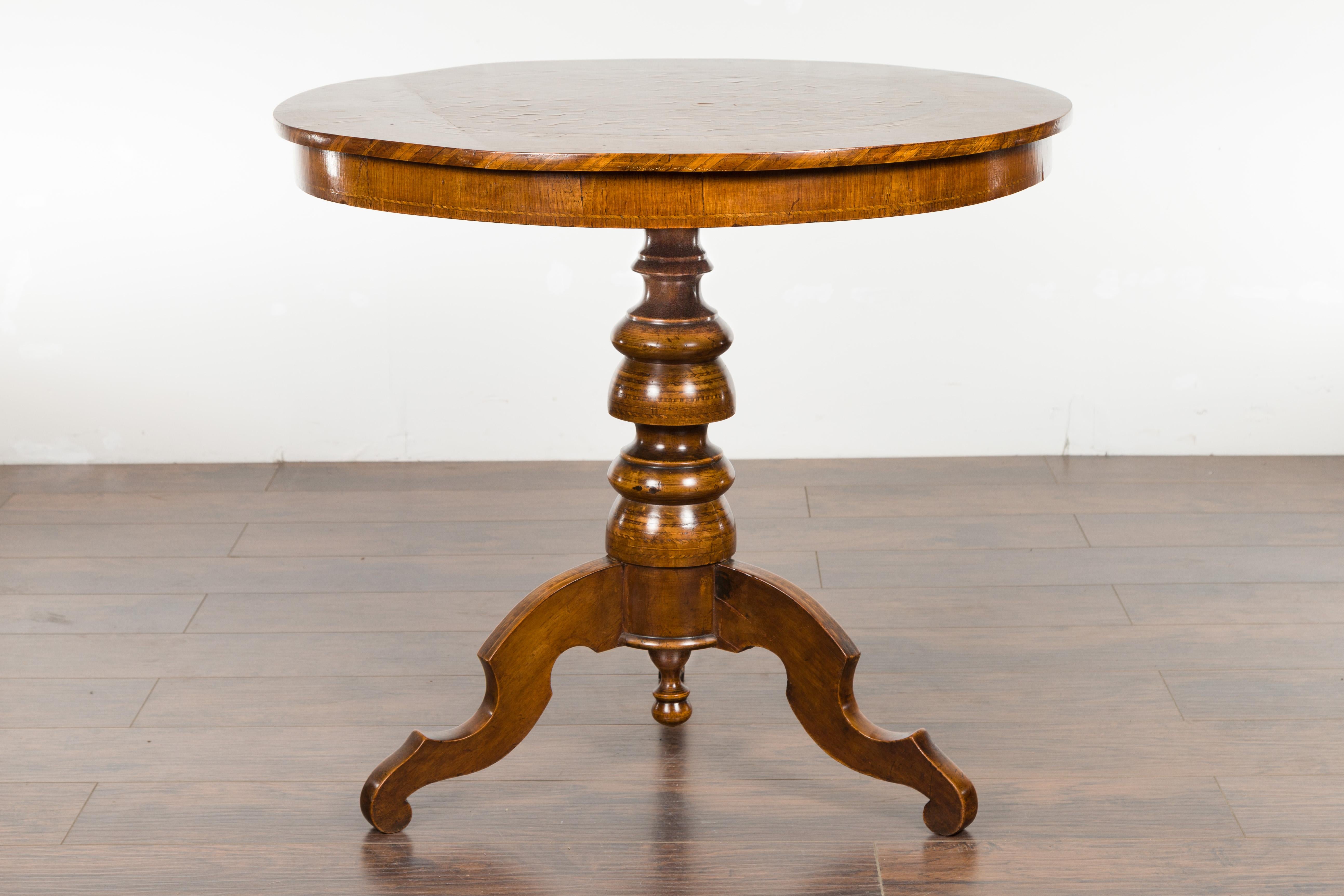 An Italian walnut Sorrento pedestal table from the late 19th century, with marquetry top and tripod base. Created in Southwestern Italy during the last quarter of the 19th century, this walnut table features a circular top adorned with exquisite