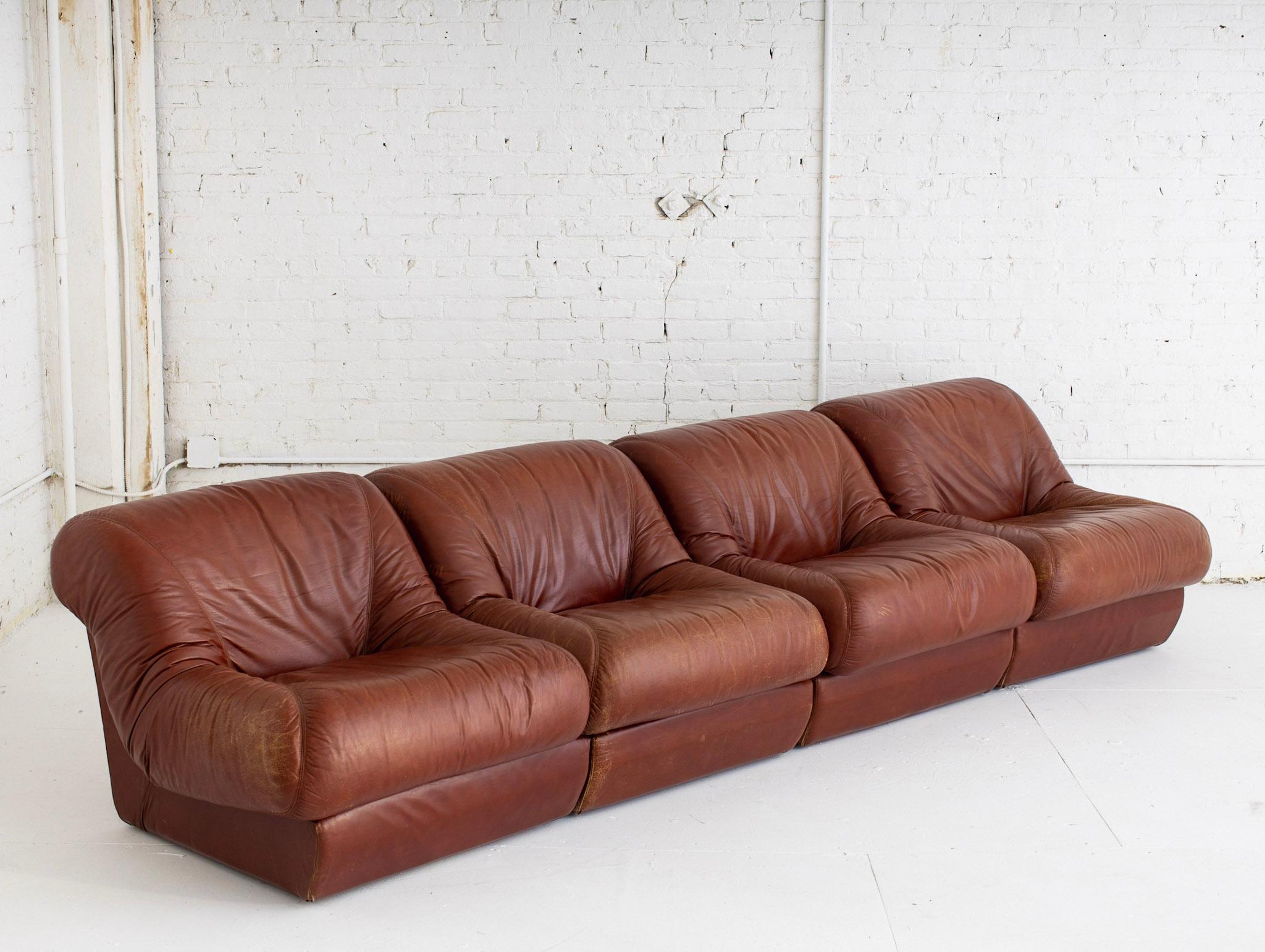 4 piece modular sofa in original caramel leather. 1960s Italian design. Sourced outside of Florence, Italy. Sections can be arranged independently or together at your discretion. Each section measures 33” wide.