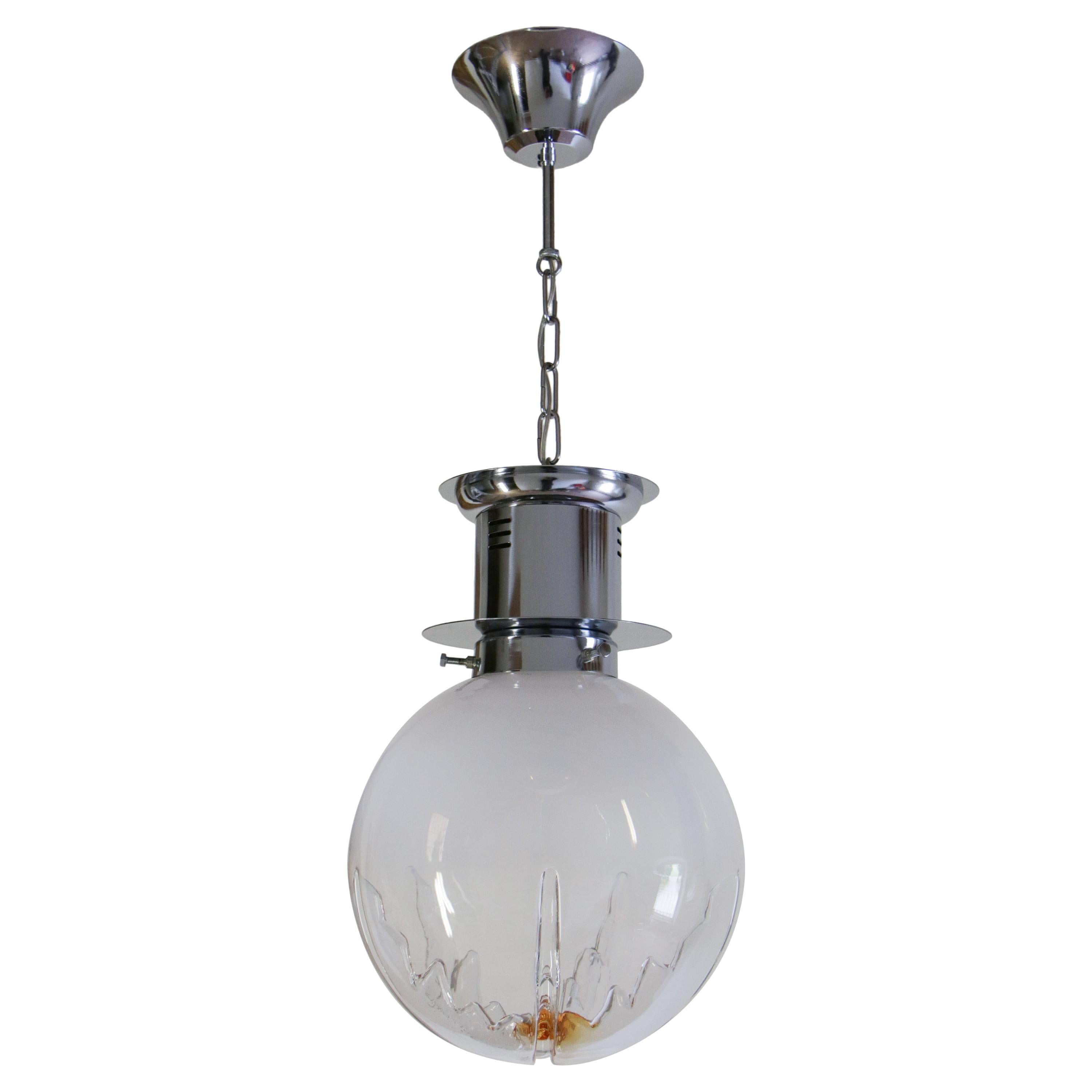 Italian Space Age ball pendant ceiling lamp in smoked glass with a touch of orange, attributed to Mezzega, from the 1970s. The structure and the pendant chain are in chromium steel. The blown smoked glass, apparently, is divided into six parts. A