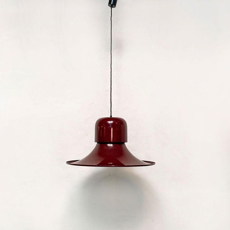Italian space age burgundy The Hat chandelier by Joe Colombo for Stilnovo, 1974
The Hat chandelier, in burgundy enamelled metal and opaque white interior, with E27 fitting.
Produced by Stilnovo in 1974 and designed by Joe Colombo.
Brand on the