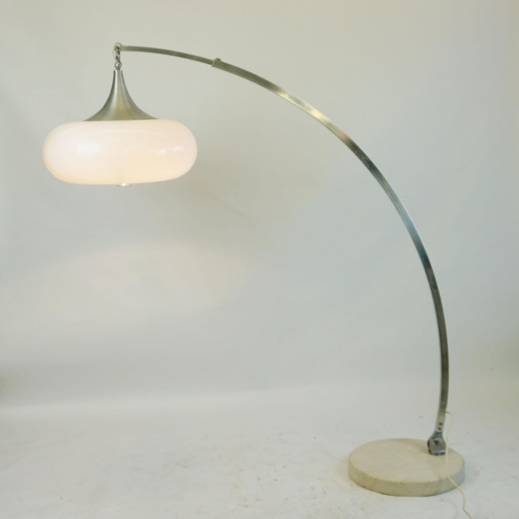 This amazing very large Italian arc floor lamp was designed and produced in Italy in 1960s, its Design is very close to lamps by Guzzini or Reggiani. 
This lamp features a chromed metal structure with circular marble base and a large white plastic