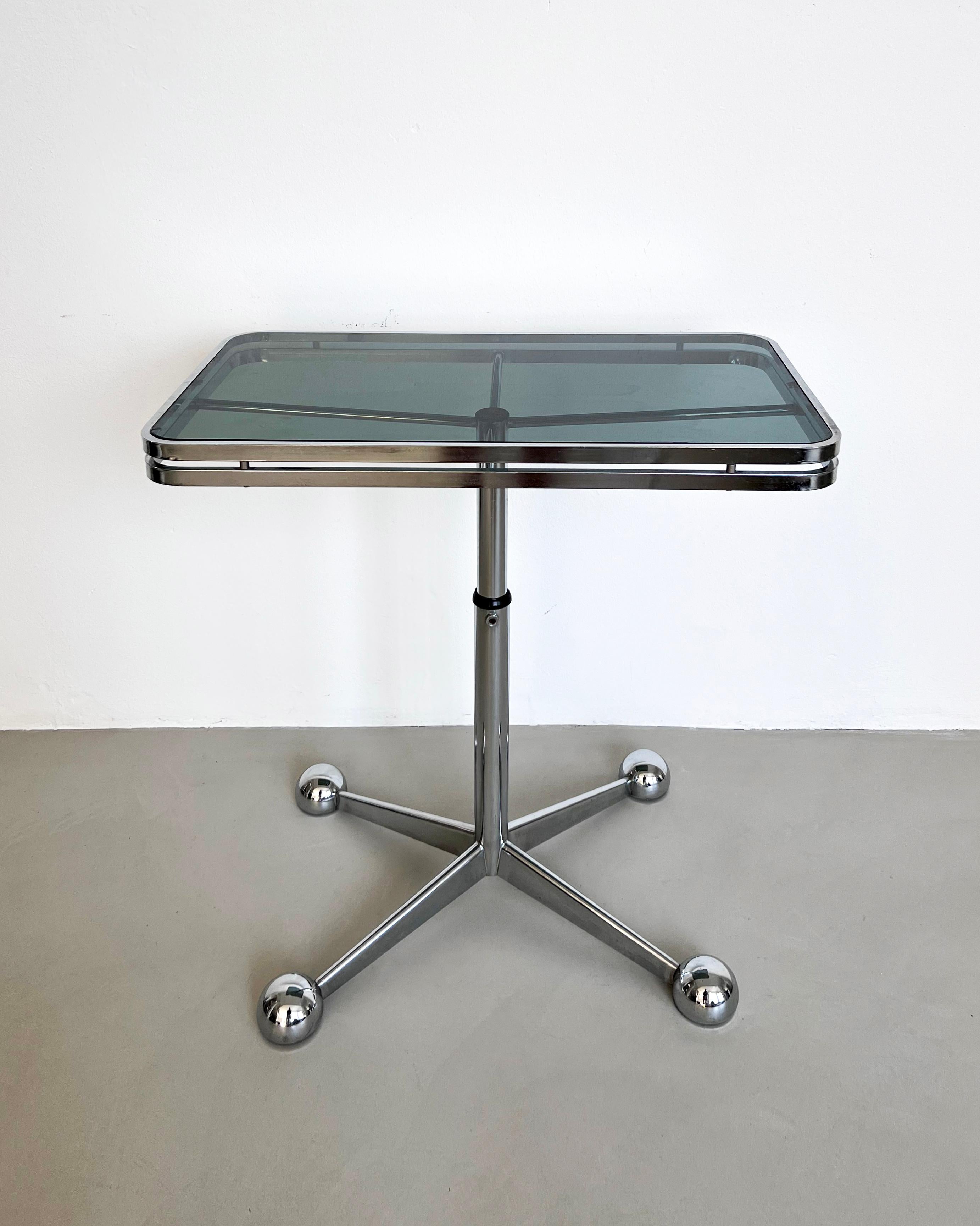 Vintage chromed metal and smoked glass telescopic adjustable table, made in Italy in the 1970s, Space Age period/style.

Labelled by famous furniture manufacturer Allegri, based in Parma, in Northern Italy, this table was originally intended as a TV