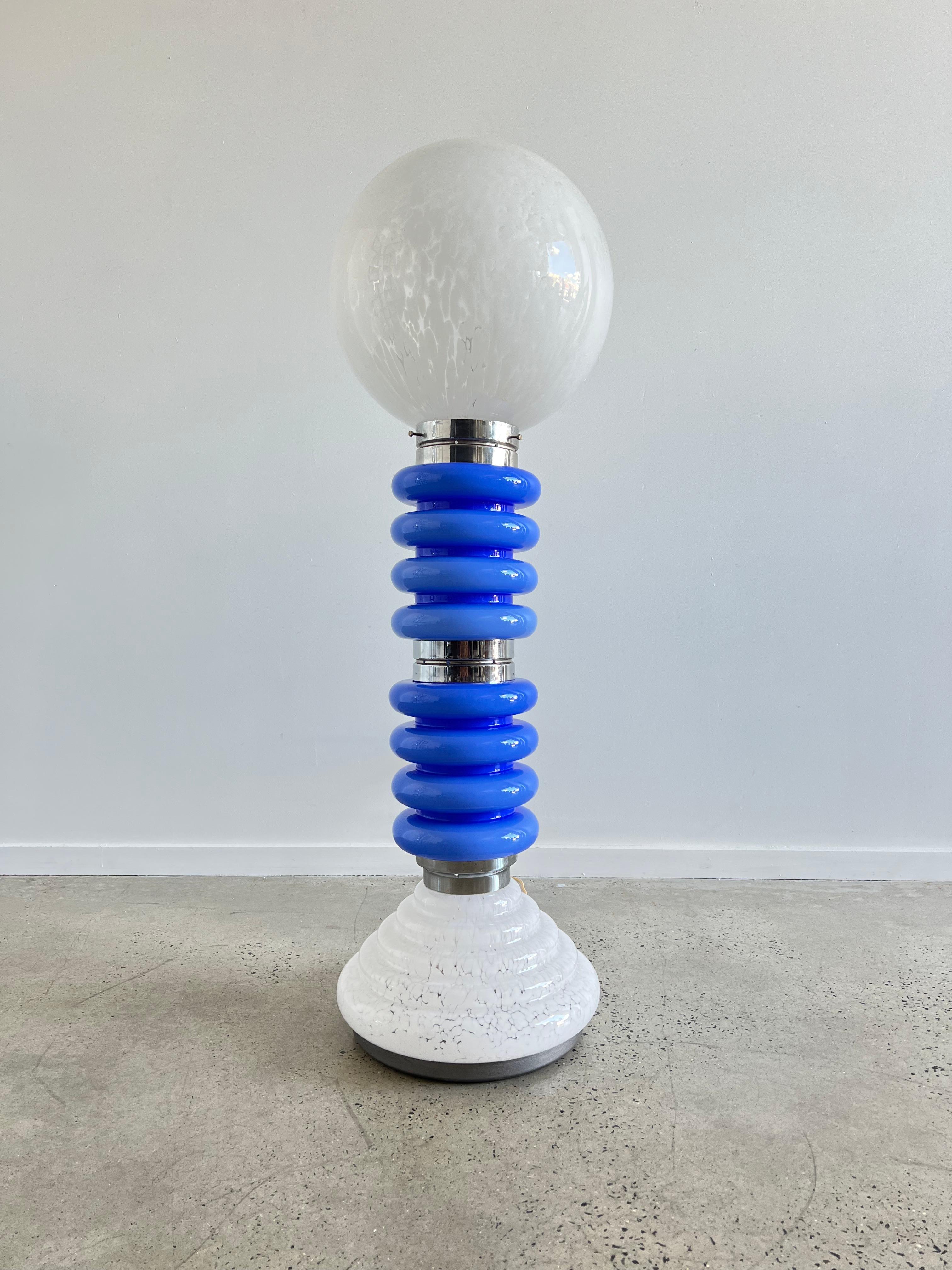 Timeless floor lamp by Carlo Nason for AV Mazzega.
Beautiful space age blue colour with a white Murano glass globe shade. The entire lamp is made out of glass with chromed center pieces.
The lamp works with two regular E26/E27 light bulbs. Good