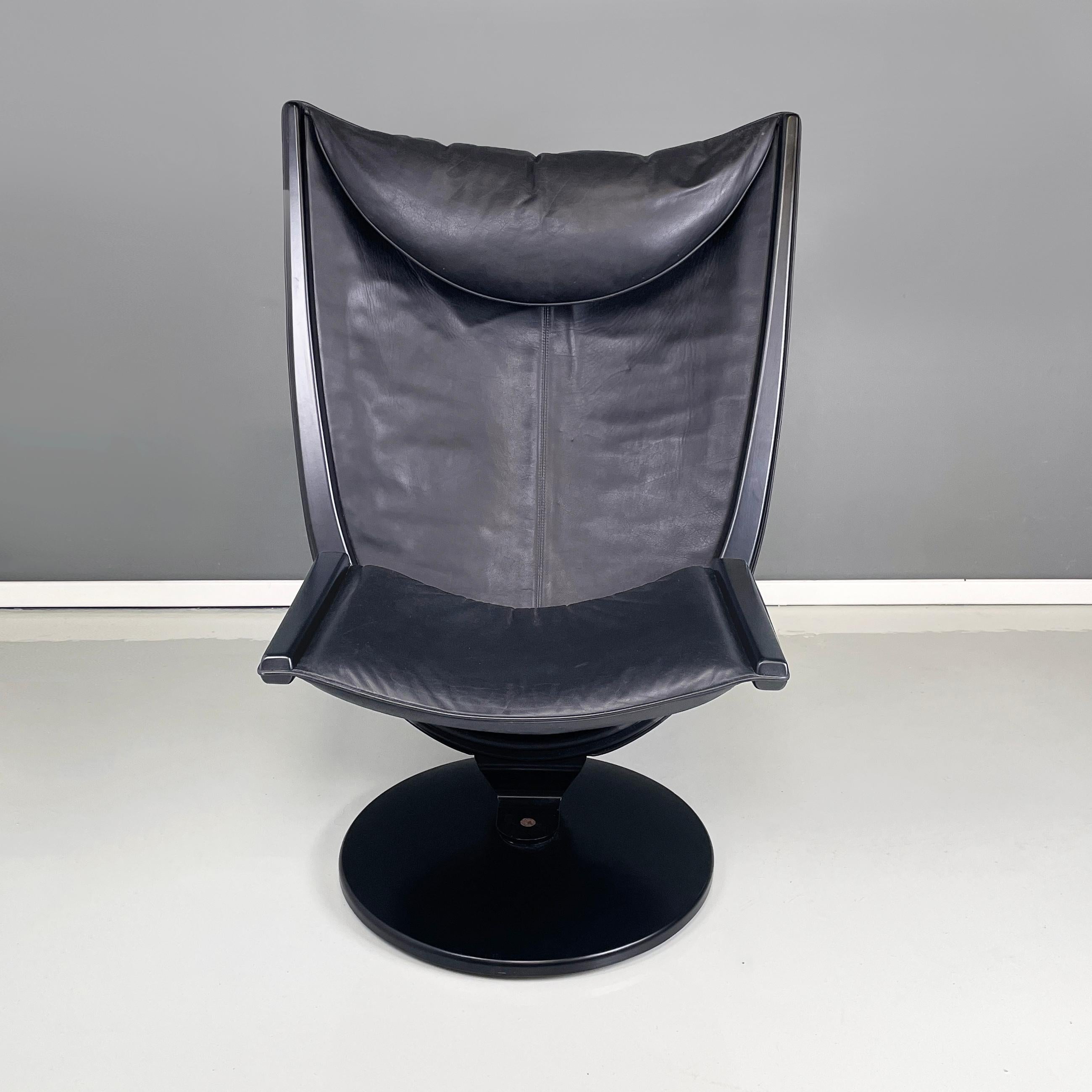 Italian space age modern  black wood and leather Armchair by Westnofa, 1980s
Armchair with round base in black painted wood. The armchair has back and seat, padded and covered on the front in black leather and on the back in black fabric, with a