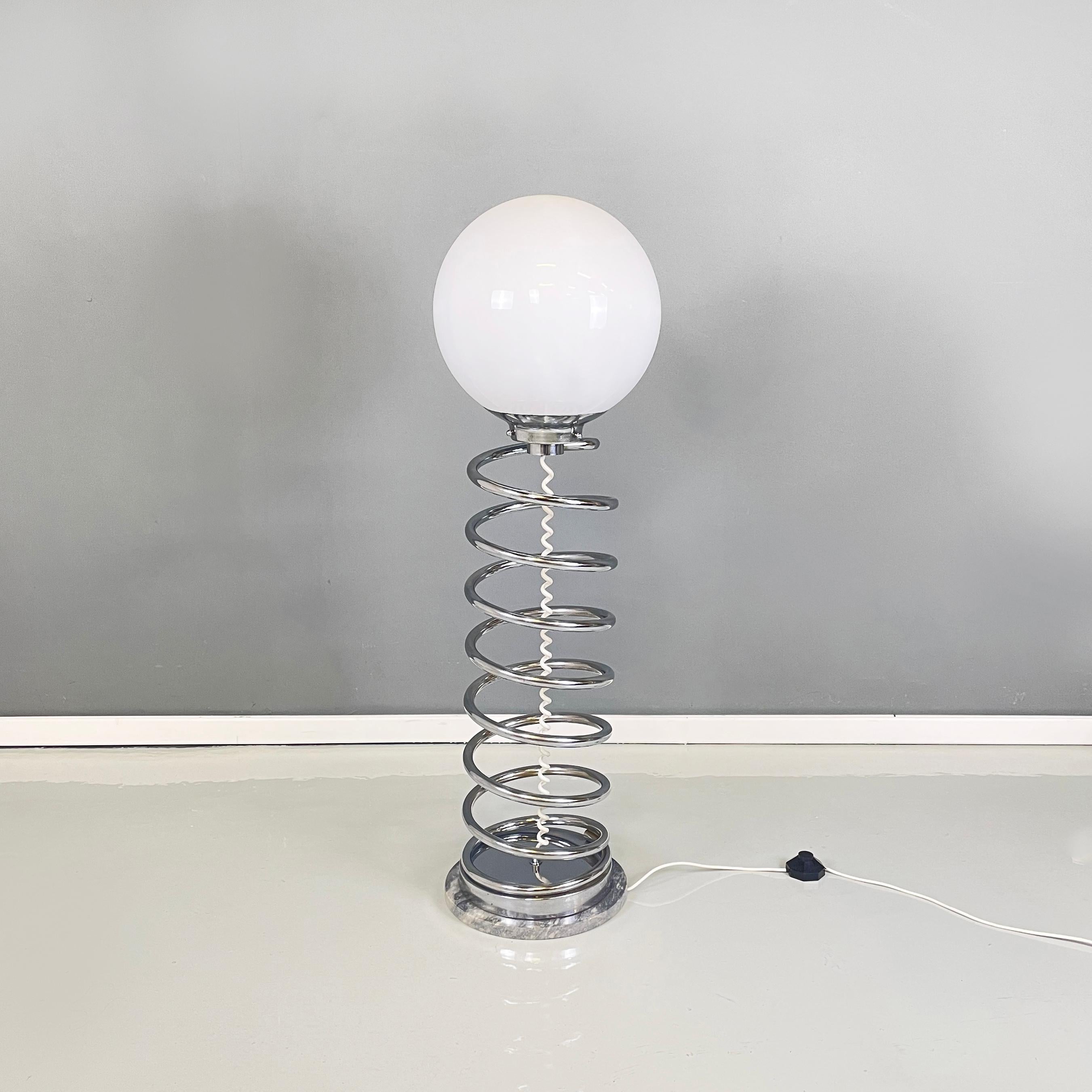 Italian space age modern Floor lamp with opaline glass, metal and gray marble, 1970s
Floor lamp with spherical opaline glass diffuser with internal decoration, visible only when turned on. The central structure is made of spring-shaped metal tubing.