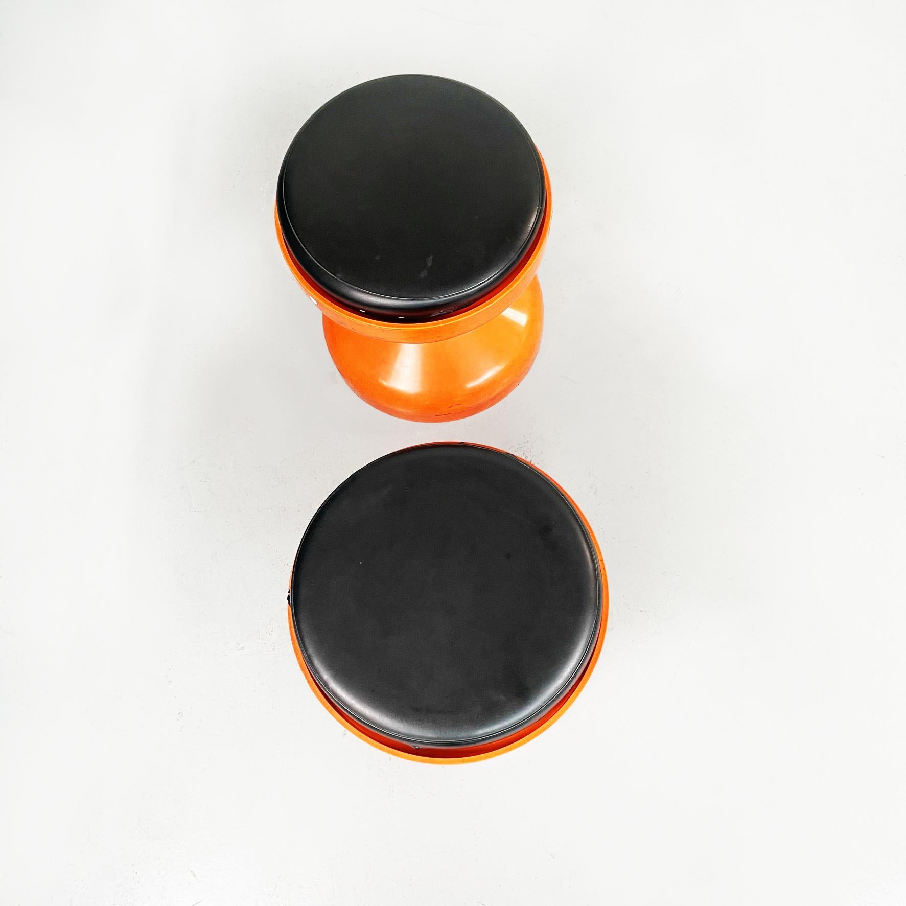 Italian space age orange plastic Rocchetto stools by Castiglioni for Kartell, 1970s
Pair of Rocchetto stools in bright orange plastic. The structure has a sinuous shape: it's tightens in the middle and widens towards the base and seat. A black