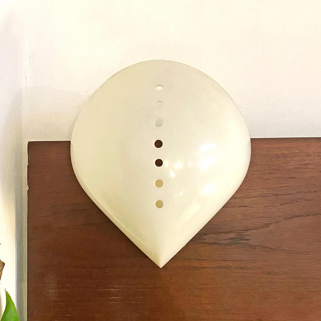 Italian space age plastic wall lamp Lola by Mazza & Gramigna, Quattrifolio, 1974
Lola model wall lamp with irregularly shaped plastic structure with holes on the front, through which the light passes, and two side inserts that hold together the