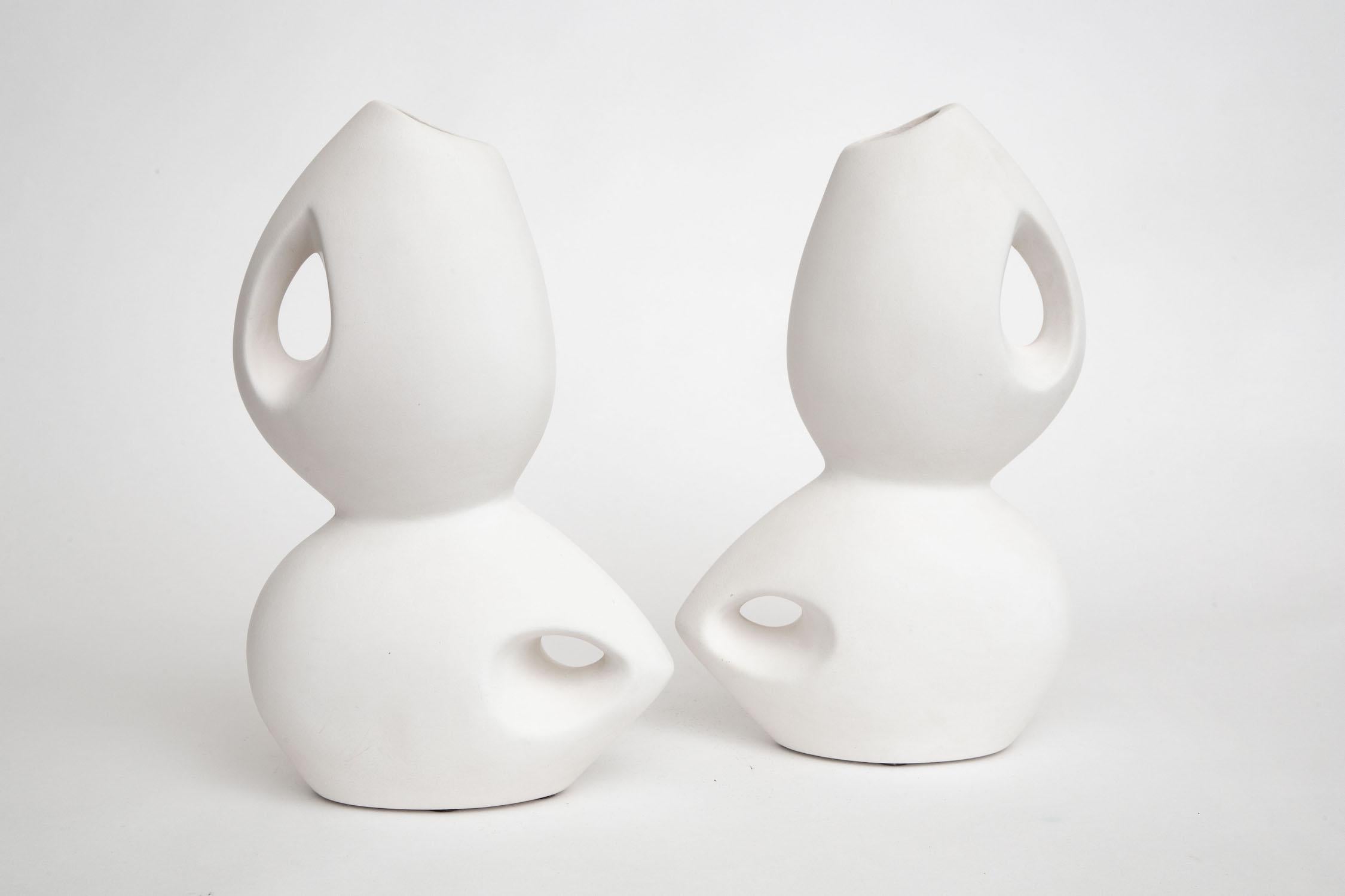 This wonderful pair of Italian white sculptural ceramics are from the 60's and very Space Age. They have great form and make a great duality. They are not signed but obscure and the maker is not known.They are organic modern. They are not heavy and