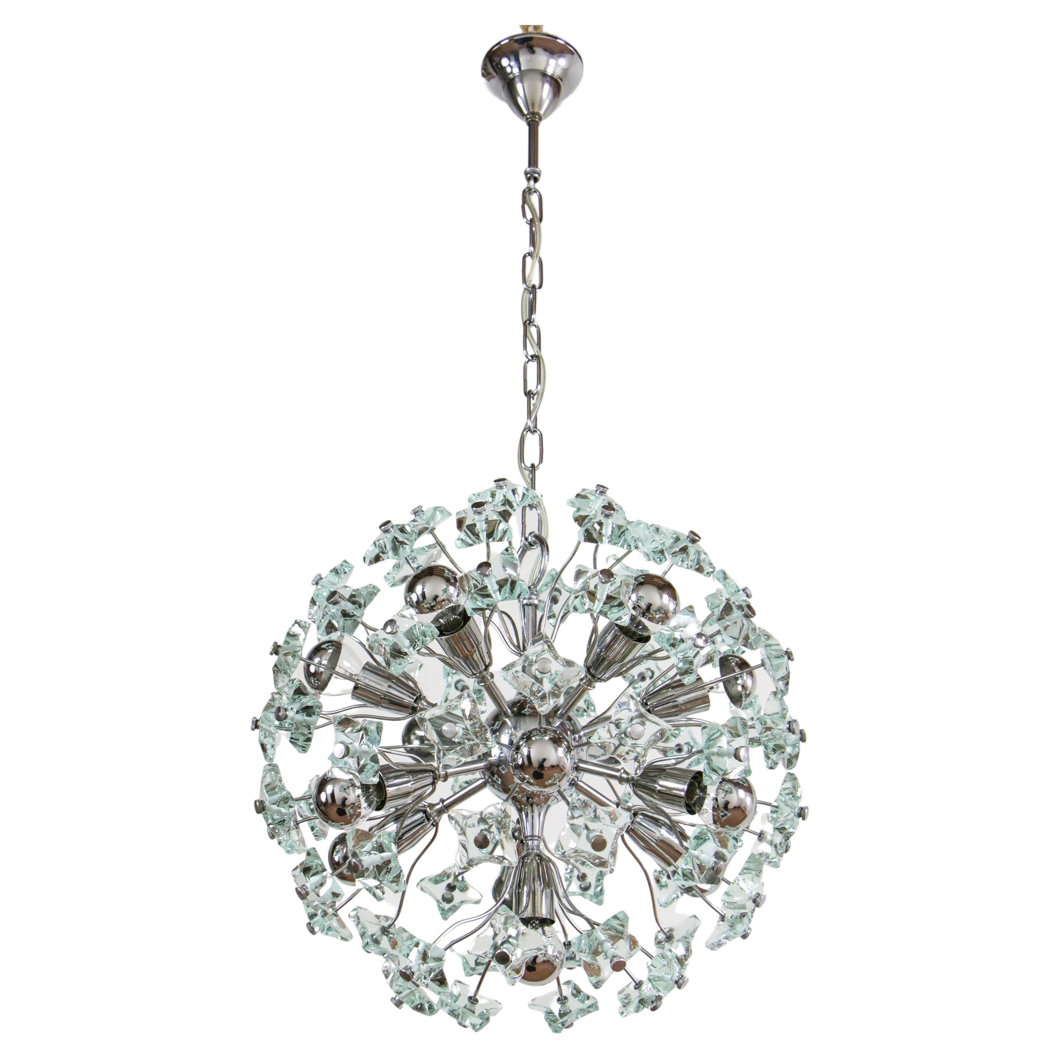 Beautiful Italian mid-century Sputnik chandelier attributed to Fontana Arte, from the 1960s. Crystal, chromed brass, 13 E14 lights. One of the rarest versions of this exquisite decorative item is here. The upper part of the crystals has been left