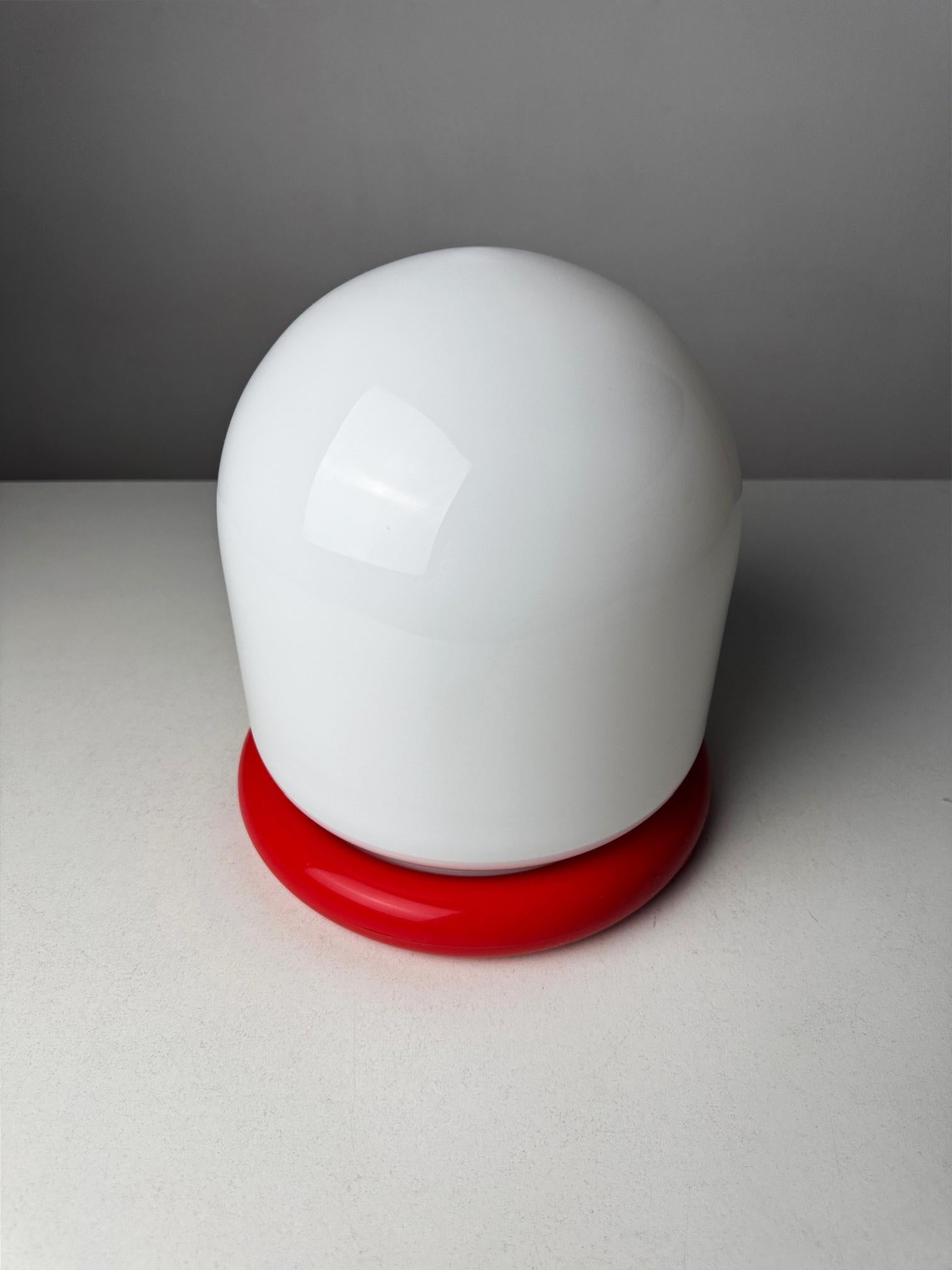 Italian Space Age Table Lamp, 1970s

A striking example of Italian Space Age design, this sculptural table lamp from the 1970s captures the futuristic aesthetic of the era. Featuring a bold contrast of materials and forms, the lamp combines a glossy