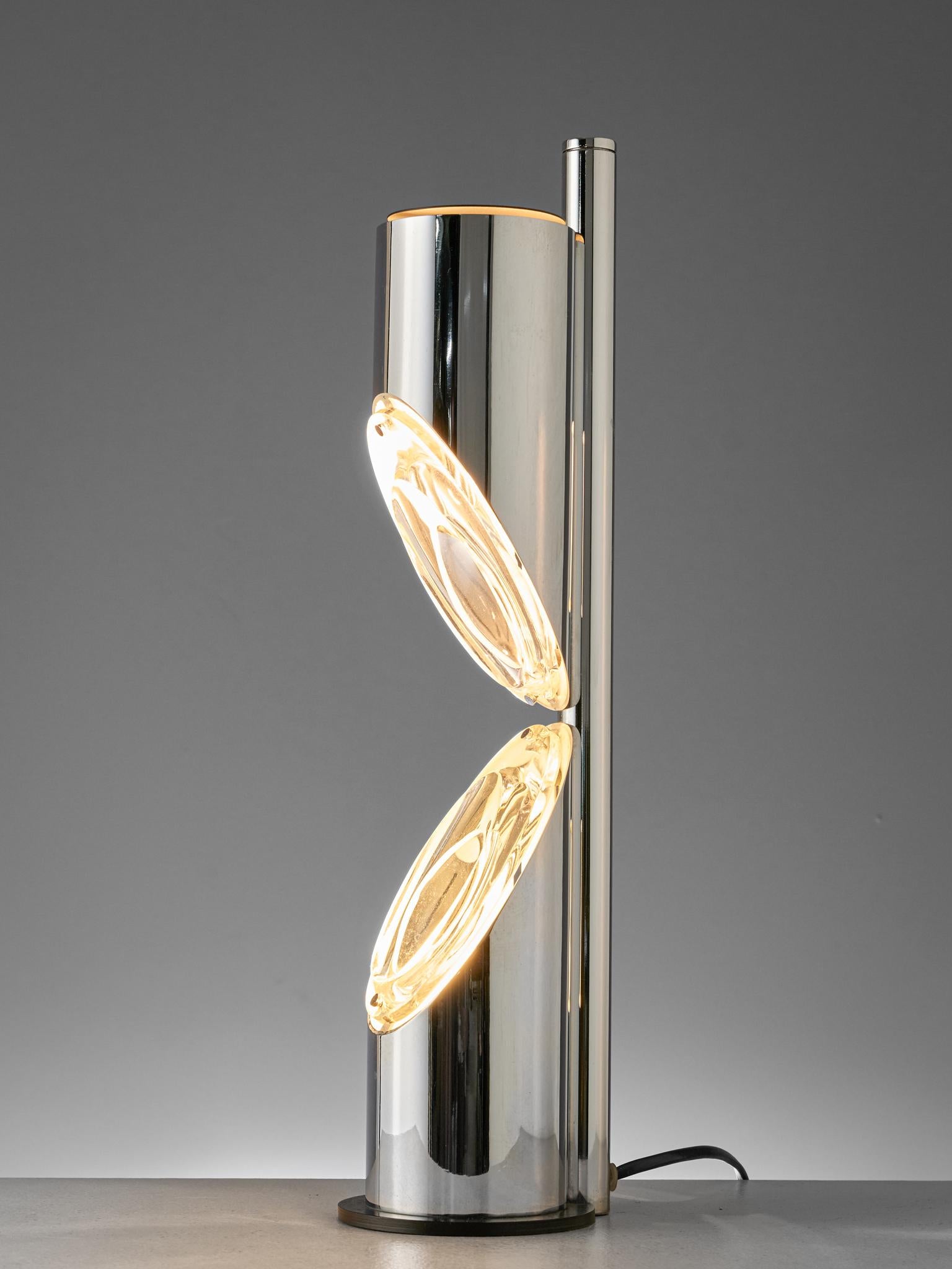 Table lamp, chromed metal, glass, Italy, 1970s

Large chromed metal table lamp manufactured by Luci Illumiazione Cinisello Milano. A futuristic space age design with two metal tubes with each one diagonal side that hold a light source. The light