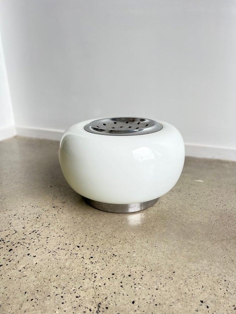 Lampe de table italienne Space AGE en verre opalin et Chrome années 1970.
Lampe de table en opaline avec couvercle central chromé et compartiment en dessous pour y placer des fleurs ou d'autres ornements décoratifs. 
