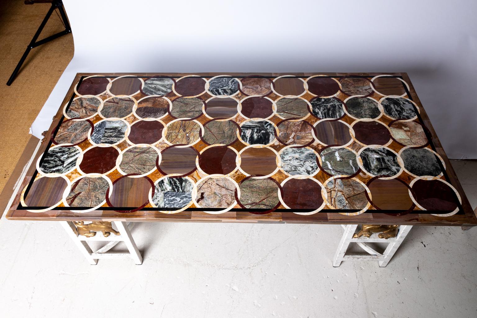 Circa early 20th century rectangular Italian coffee table with colorful marble top ornamented by various specimens of marble. The piece sits on a white painted metal base with four lion medallion motifs. Please note of wear consistent with age, the