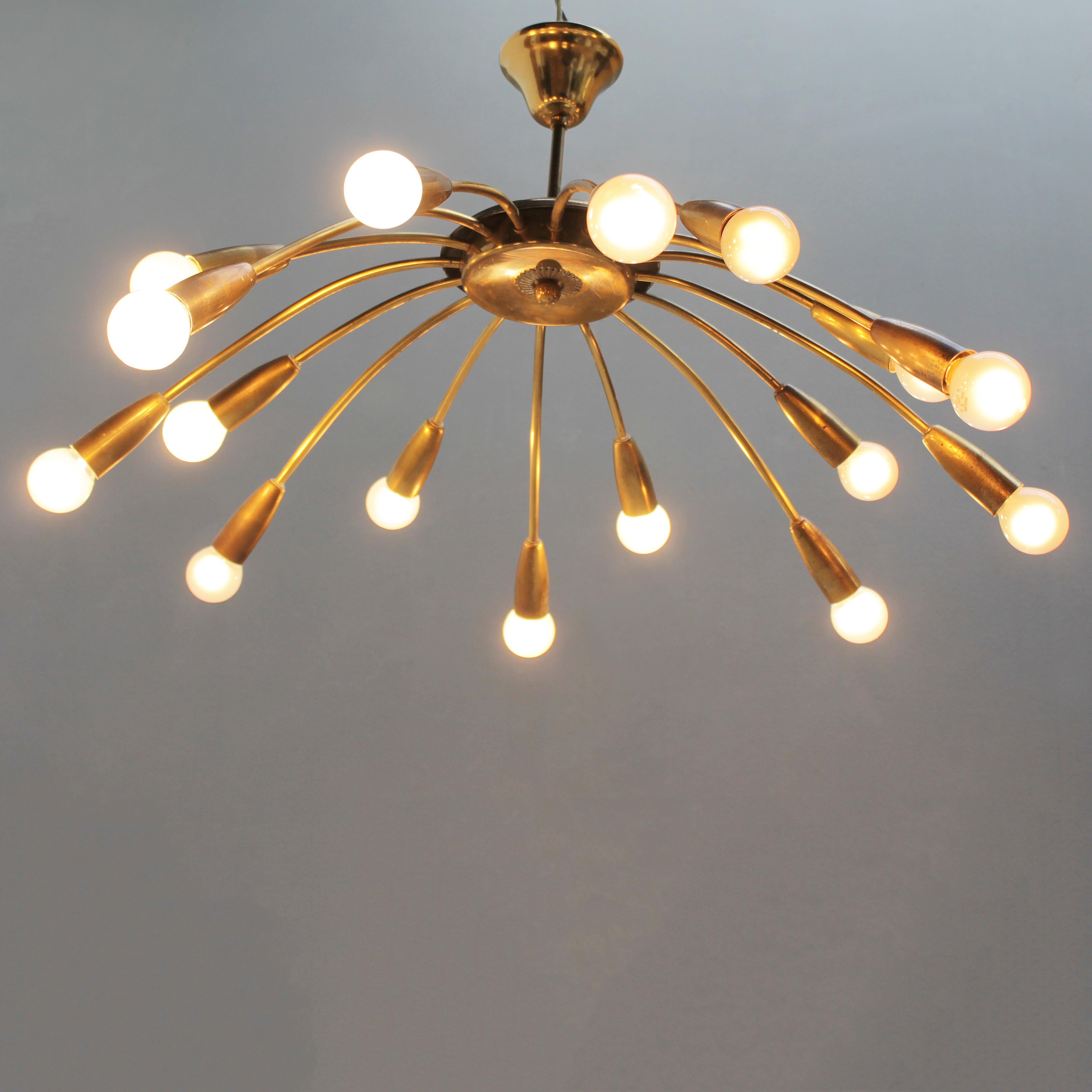 Attractive Italian midcentury chandelier executed in brass. The light has got sixteen arms, alternately long and short. The fixture is equipped small Edison screw (SES), (E17 14-17 mm max 25 watt) lamp holders, which can be fitted with E17 screw