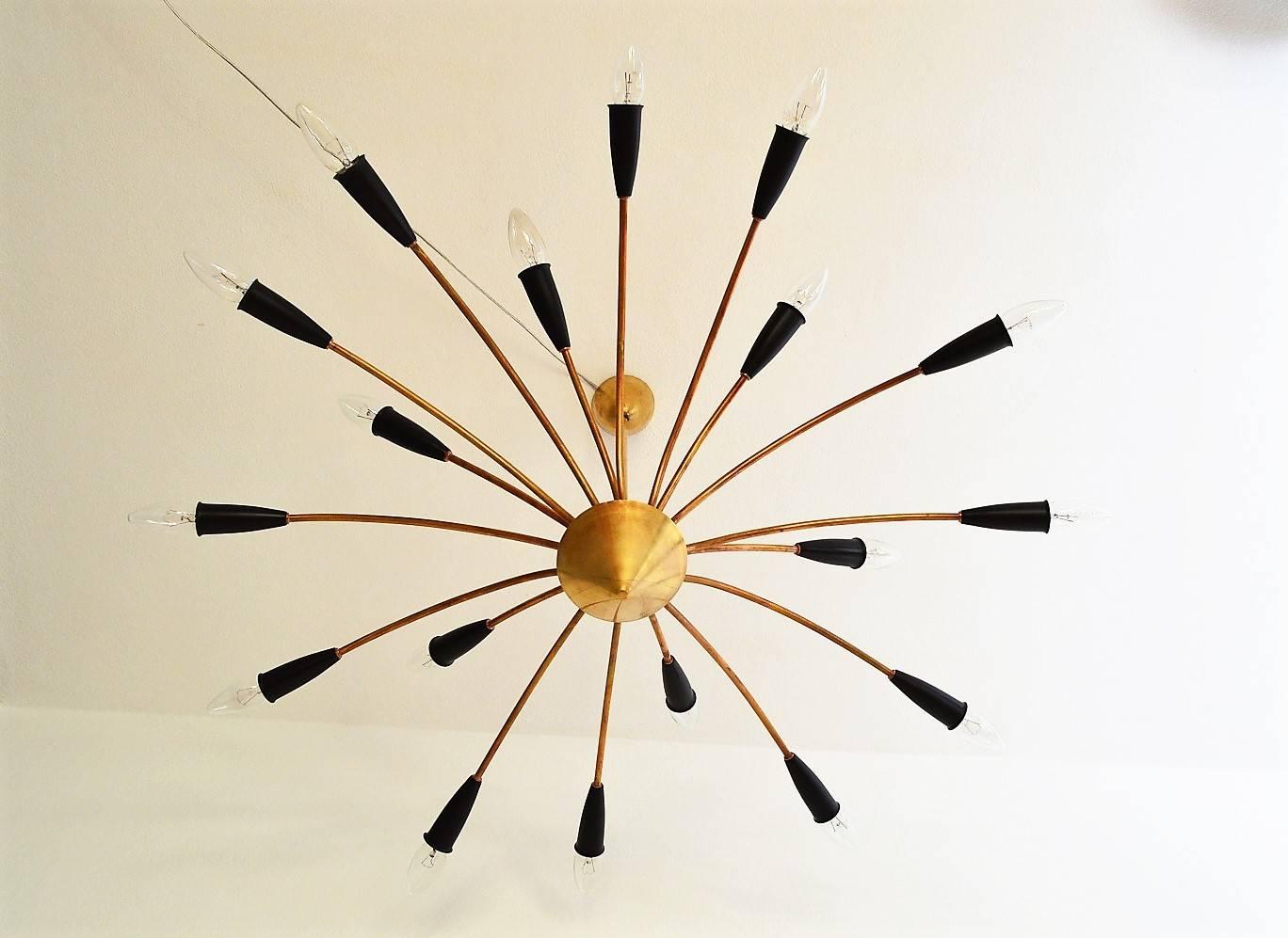 Beautiful Mid-Century Modern Sputnik chandelier or ceiling lamp with 18 arms made entirely of brass with metal details in black color.
Made in Italy in the 1950s
Completely restored and in excellent condition!
The chandelier has a diameter of
