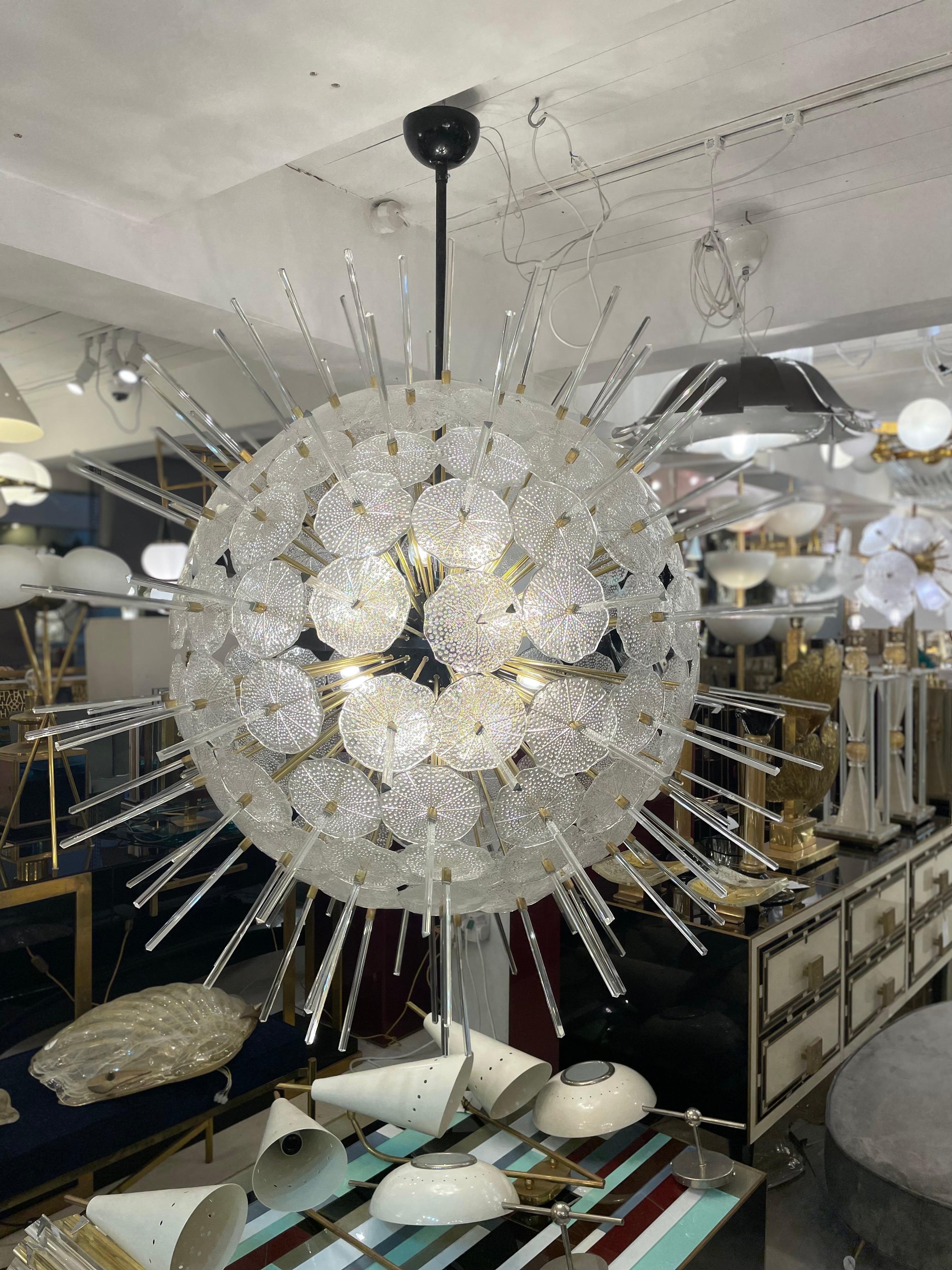 This Sputnik chandelier is made of a sphere and brass rods supports. The glass discs are hand blown Murano glass in white colour that remind “Jelly Fish” and all together create a wonderful warm glow, a truly spectacular piece of interior design. It