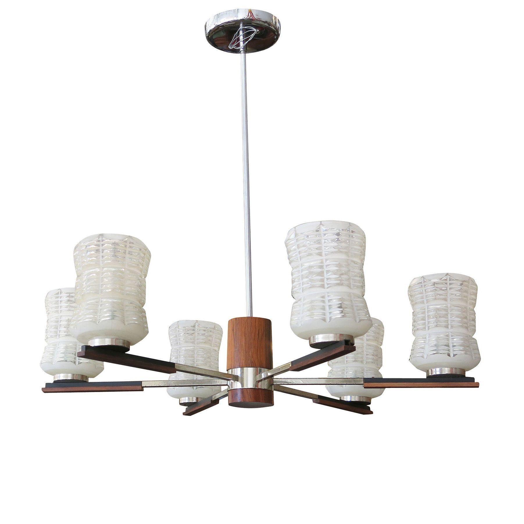Lampadario Sputnik italiano di metà secolo con bracci cromati e accenti in palissandro, circa 1960. Ciascun braccio sostiene un paralume in vetro smerigliato con intagli trasparenti.