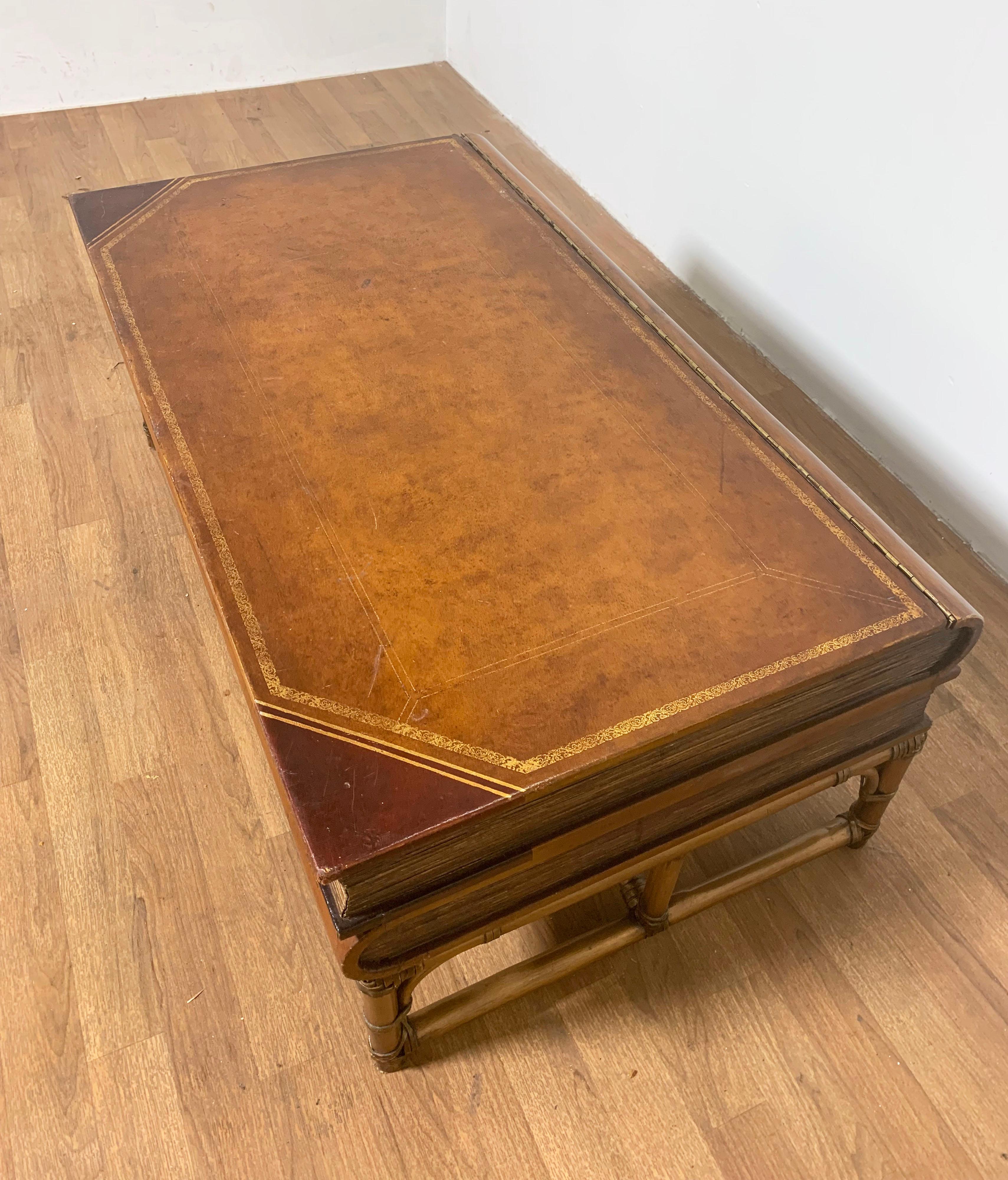 Bibliophile's coffee table, ca. 1950s and made in Italy for Neiman-Marcus, in the form of leather bound antiquarian stacked books, includes interior storage. On a rattan wrapped bamboo stand.