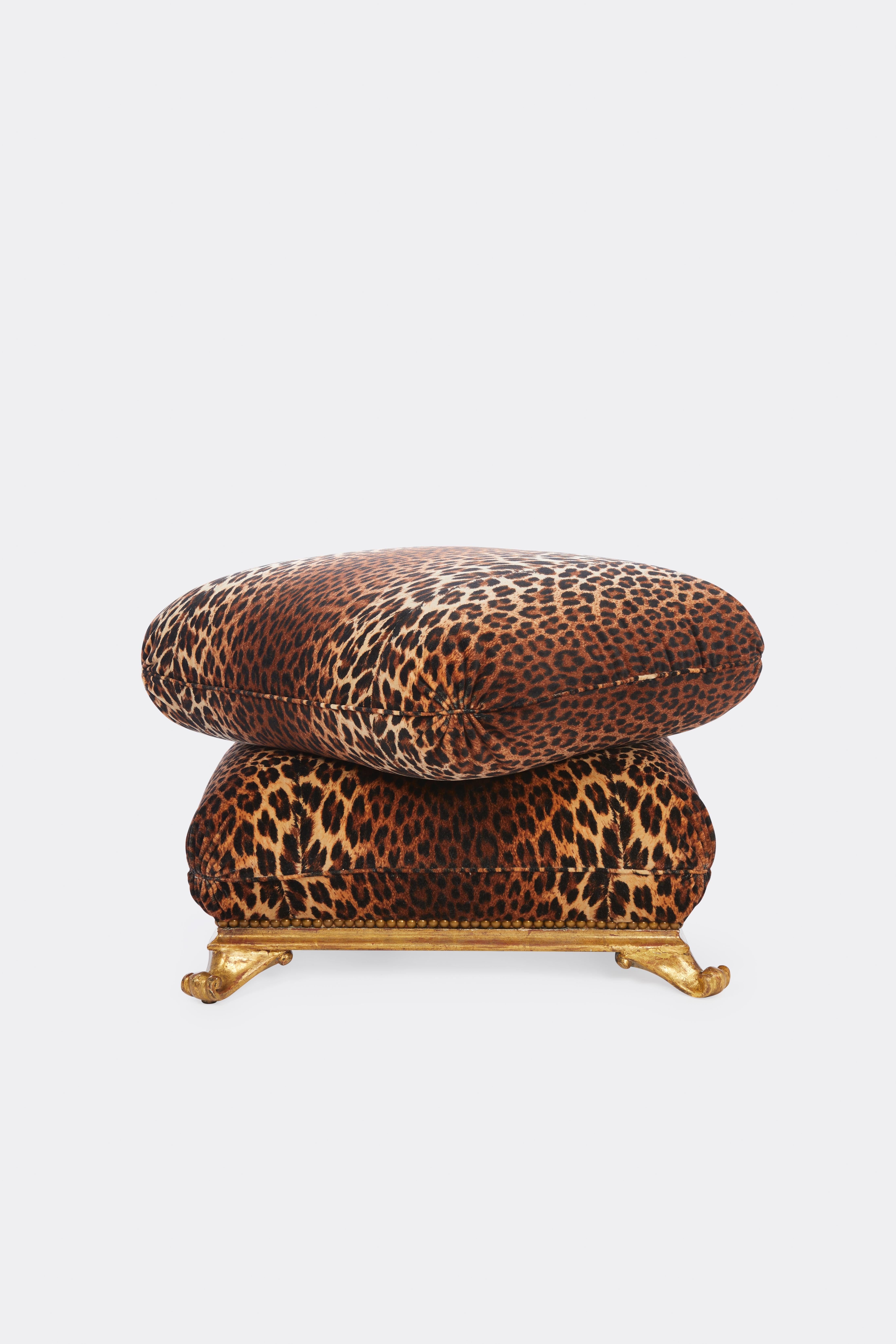A square Italian neoclassical ottoman with carved giltwood base having splayed scroll feet newly upholstered with stacked pillow design in a Pierre Frey leopard velvet.