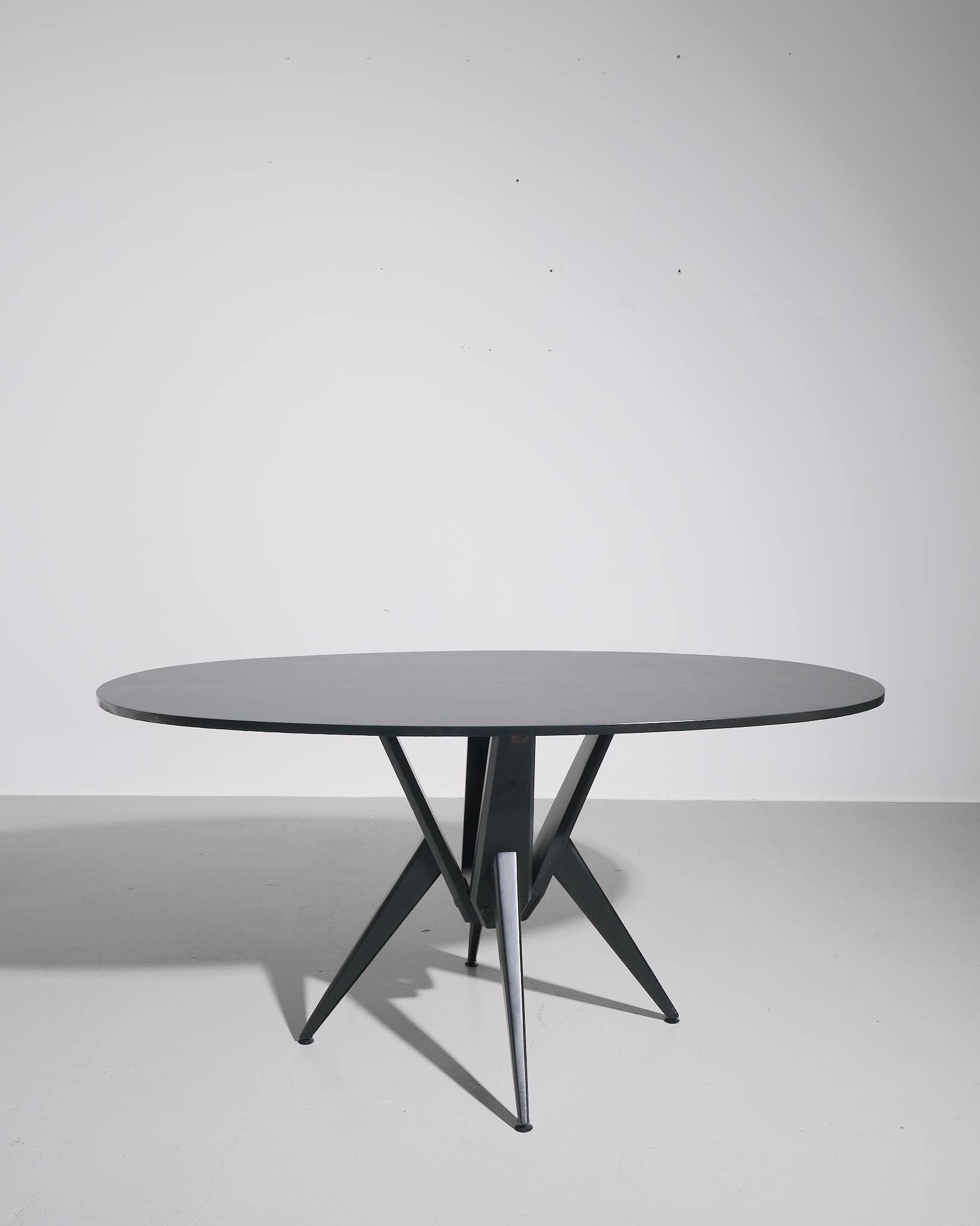 An elegant Italian dining table, crafted in stained wood and dating from the 1950s — a refined example of postwar Italian mid-century modern design. With clean, architectural lines and a gently tapered leg profile, the piece reflects the era’s