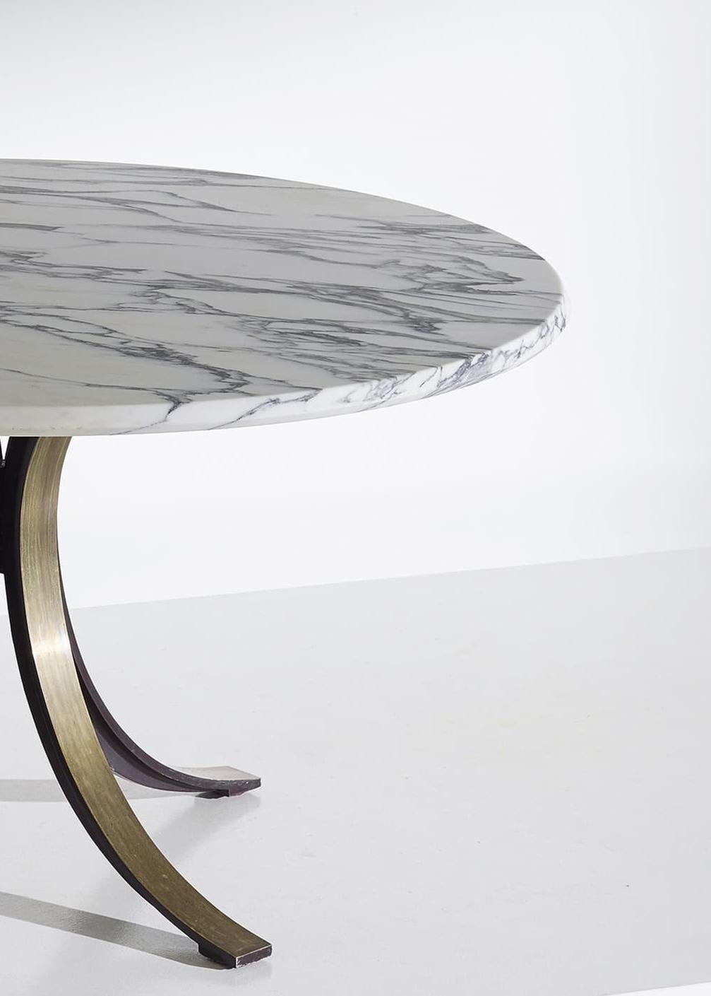 This table was designed in 1963 by Osvaldo Borsani and Eugenio Gerli for Tecno, Italy. It's Classic Minimalist deign is comprised of steel legs, metal saber feet and a white Carrara marble top. The top is removable and is fixed with four bolts.