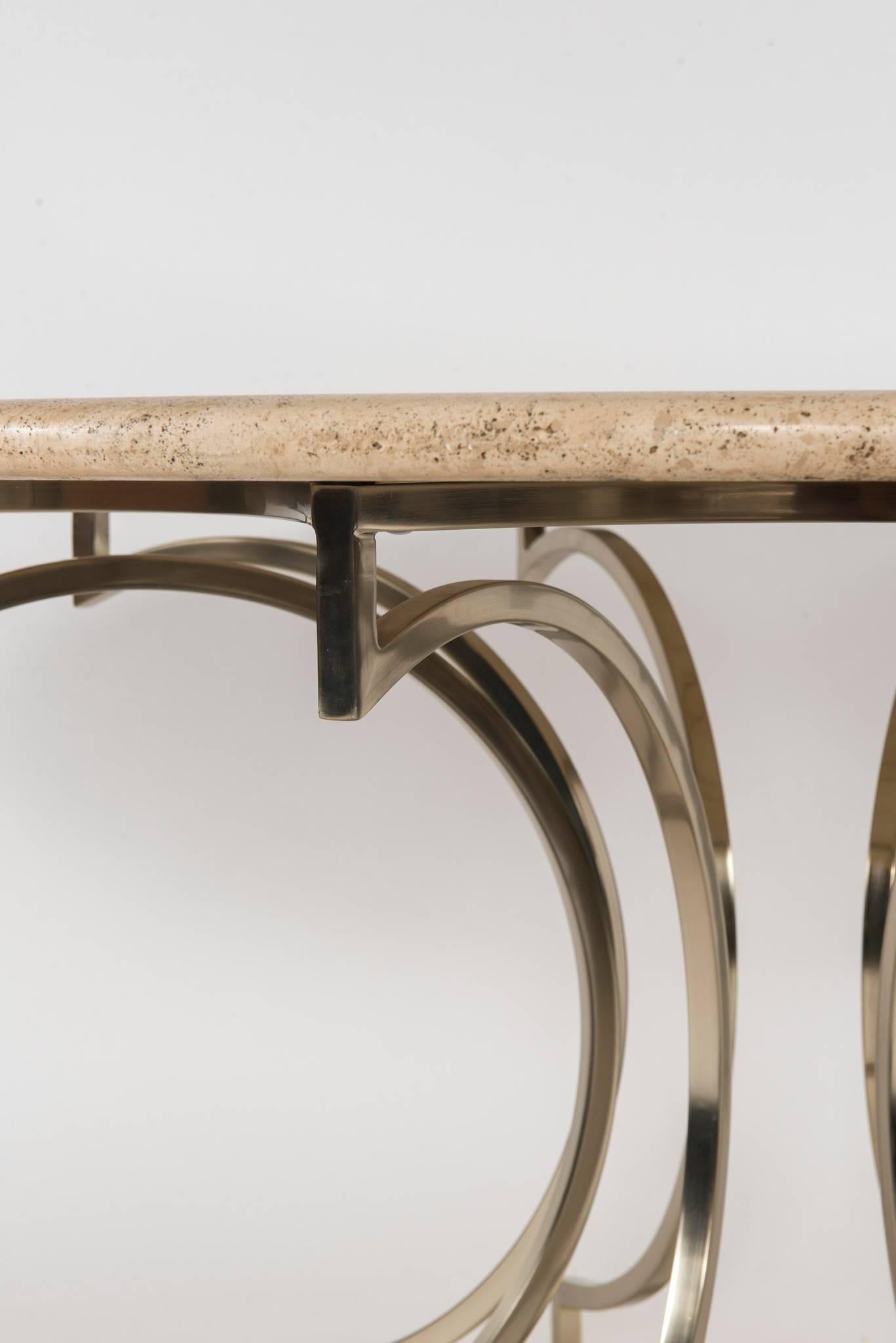 A reverse octofoil Italian steel center table base with travertine top, circa 1970.