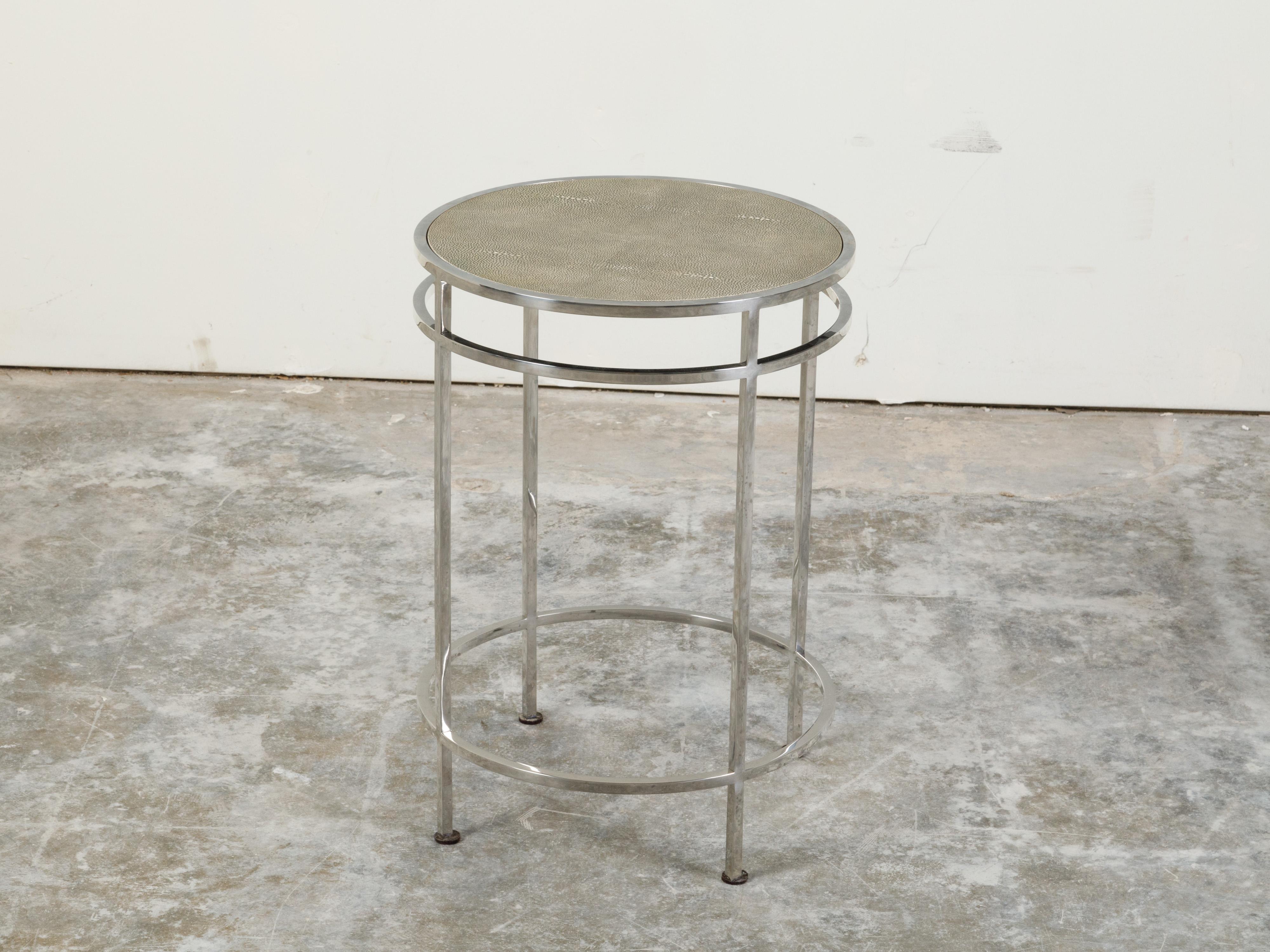 An Italian steel side table from the mid 20th century, with shagreen top and ring motifs. Created in Italy, this side table features a circular shagreen covered top sitting above four slender straight legs connected to one another through two round