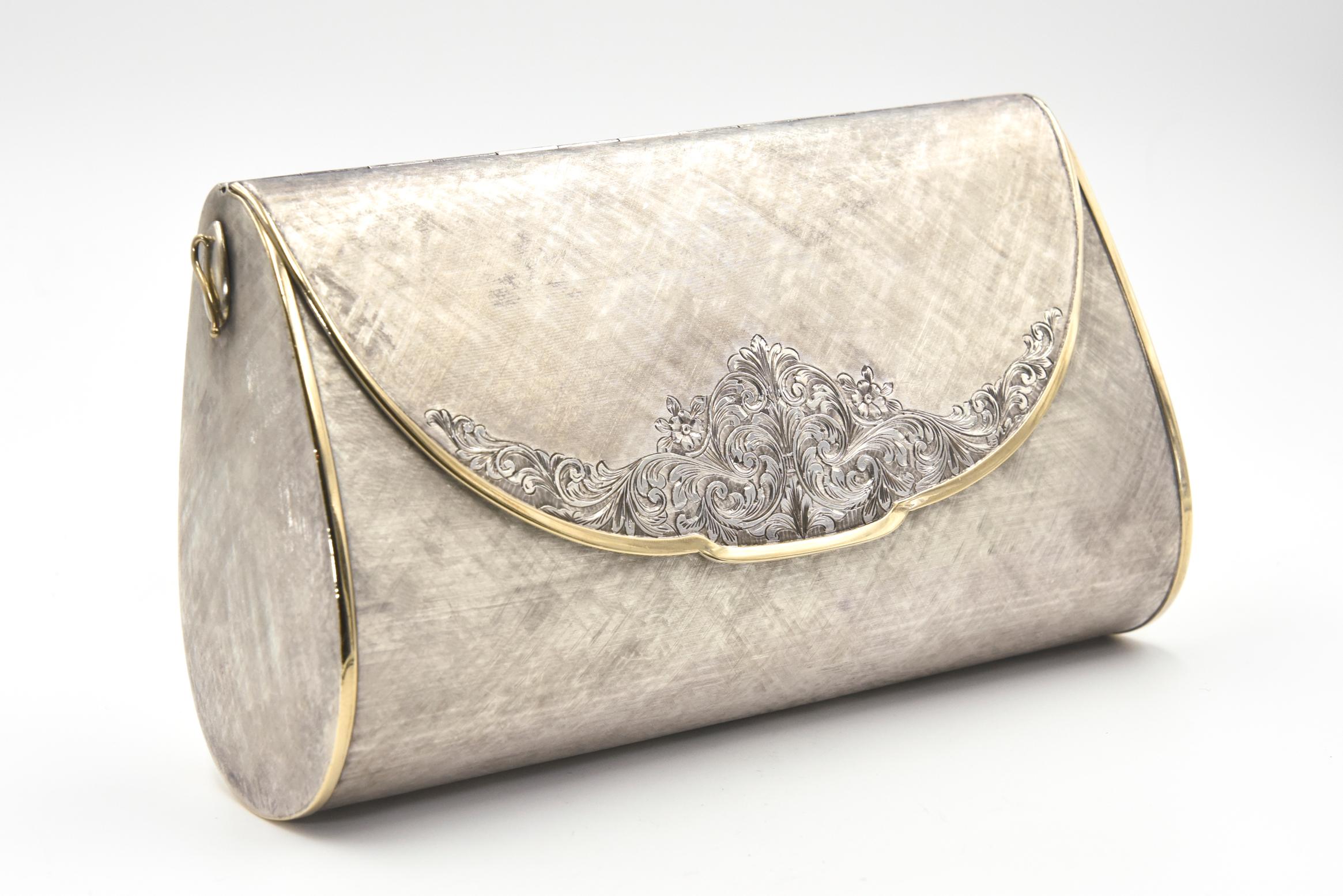 Beautifully made evening bag by Italian Marchi Leonello.  He was a Firenze silversmith between 1965 and 1971.  This sterling silver evening bag clutch is a wonderful example of the exquisite work he created.  The bag has a florentine finish with an