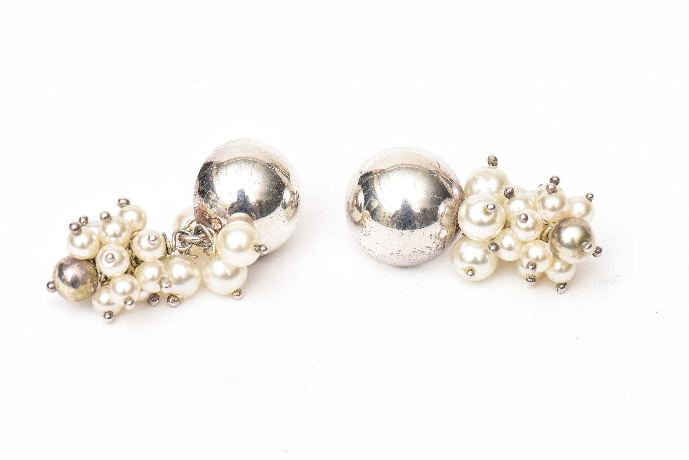These lovely and elegant cluster dangle pierced sterling silver and pearl earrings are Italian and marked  925 UTC ITALY. The pearls are connected with sterling silver pins. These are forever and can go casual to dressy. All seasons wear. Sorry the