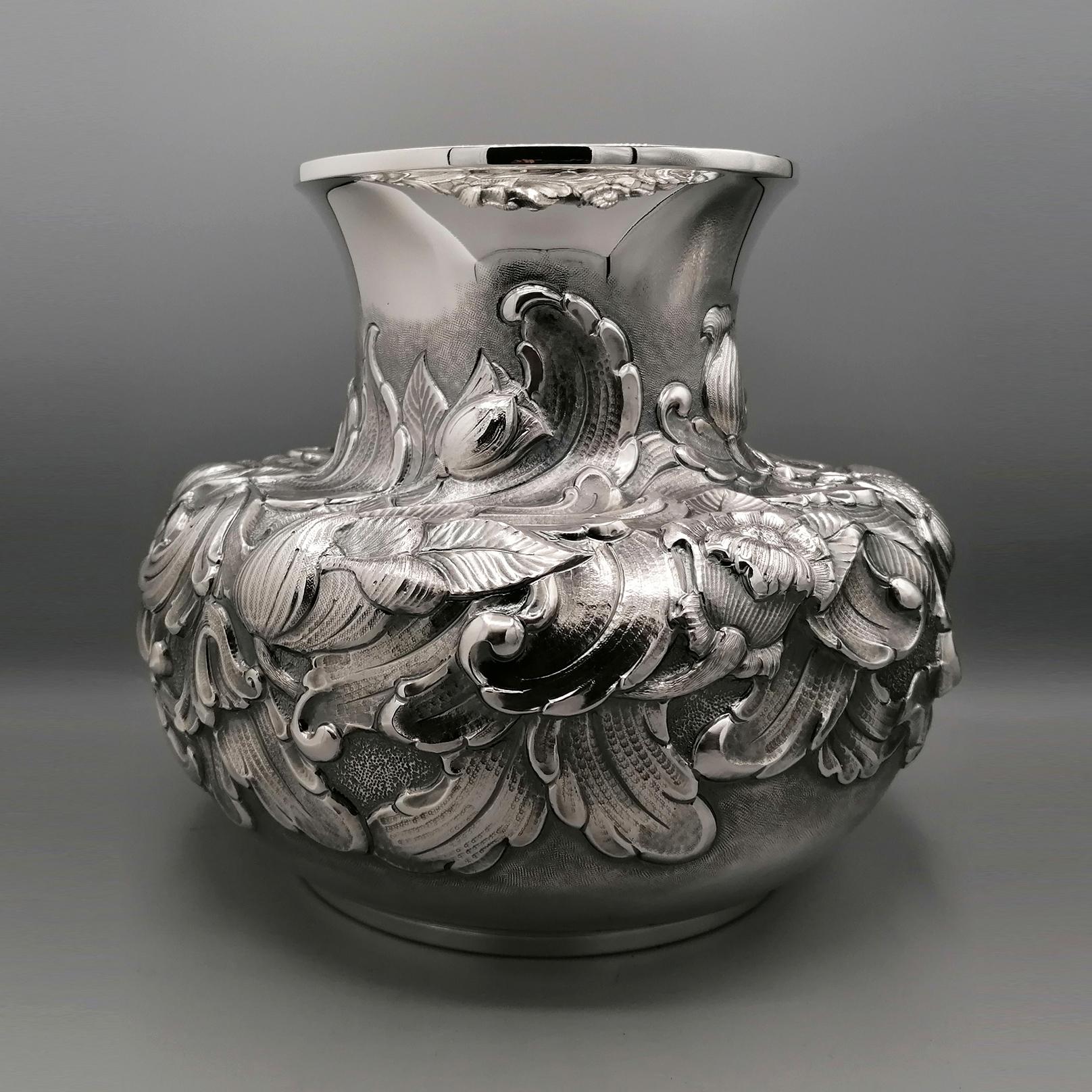 Large and impressive embossed sterling silver vase.
The body of the vase is pot-bellied while the upper part ends with a very large mouth which allows the placement of a large bouquet of flowers.
An important embossed work has been created on the