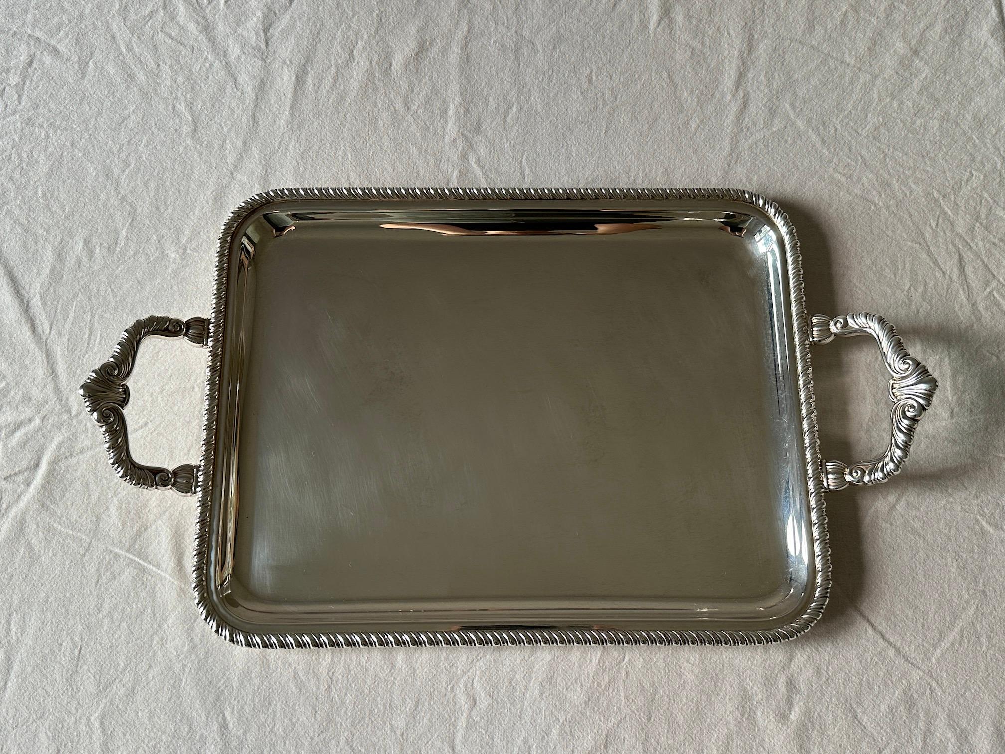 An Italian Sterling Silver serving tray in the style of Buccelati
with a classic rope border and  handles. 

 Weight - g    oz 
 Length incl Handles - 16 in  40.6 cm 
 Length excl Handles - 13 in  33 cm    
 Width - 16 in  40,7 cm 
 Height to Handle