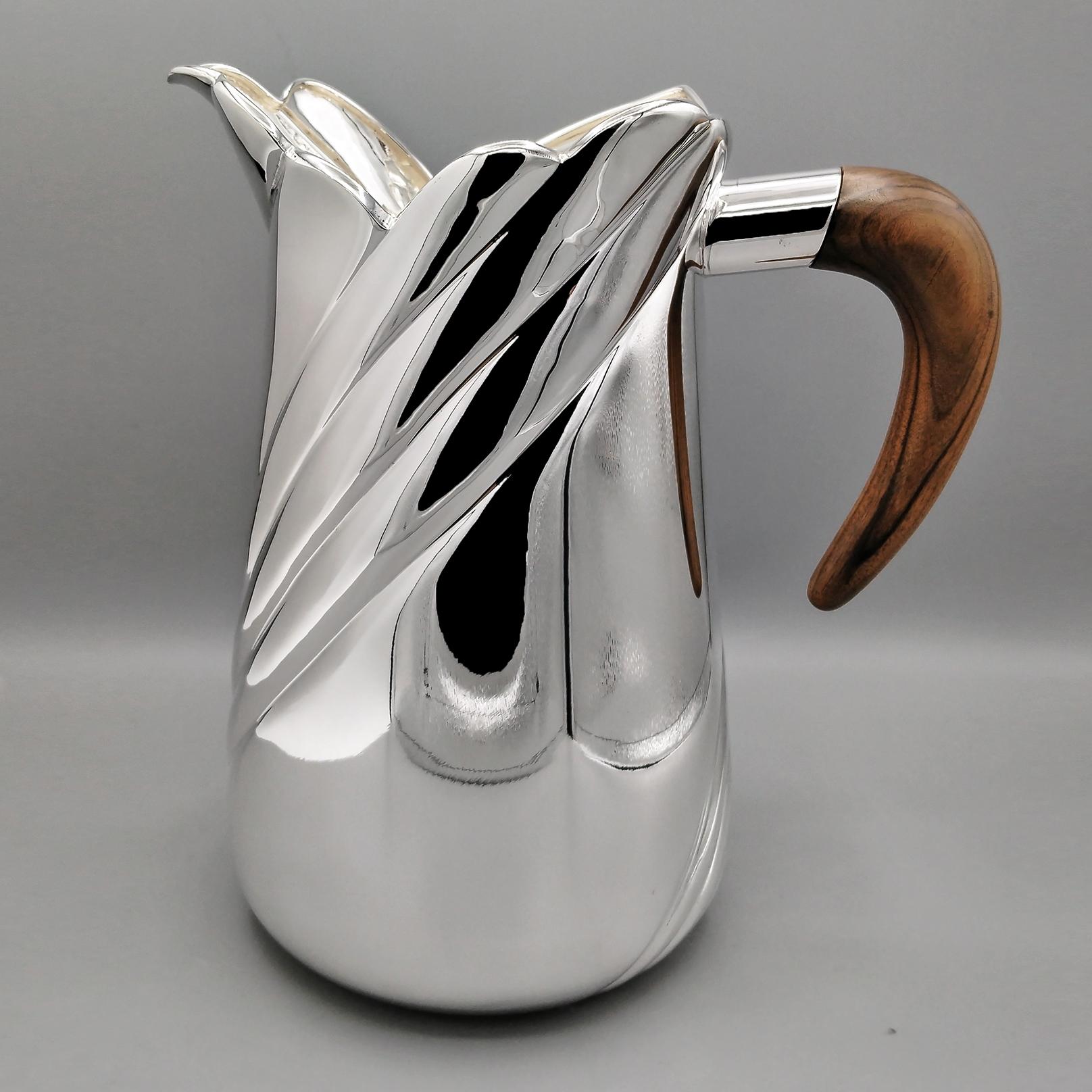 Italian sterling silver water jug with wooden handle.
The water jug was made in 2 parts, completely by hand starting from a 925 silver sheet and subsequently assembled.
A spiral embossment was then performed on the body of the jug, starting from the