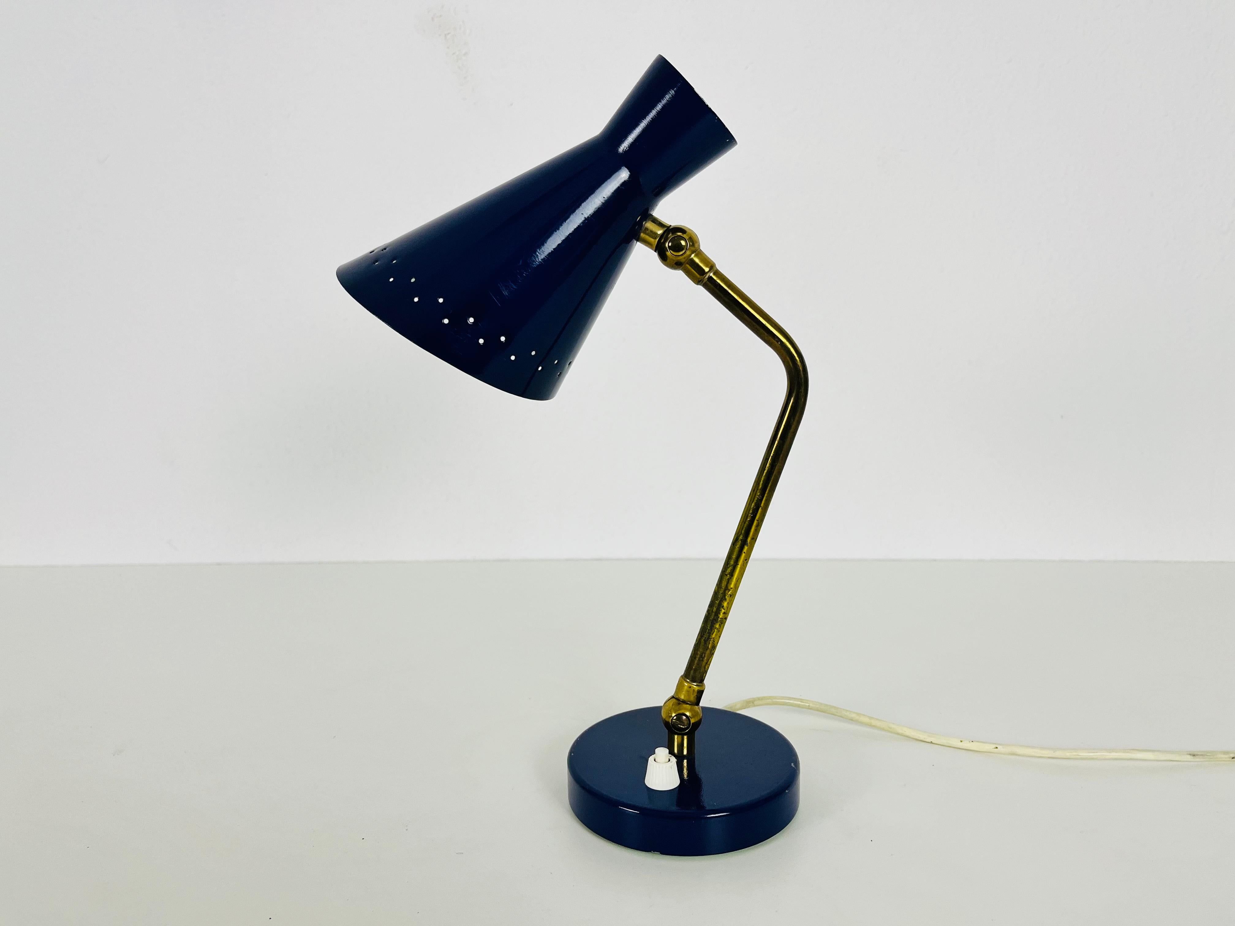 Extraordinary blue table lamp made by Stilnovo in the 1960s. The lighting has an exceptional design with beautiful brass elements.

The light requires one E14 light bulb. Works with both 120/220V. Good vintage condition.

Free worldwide express