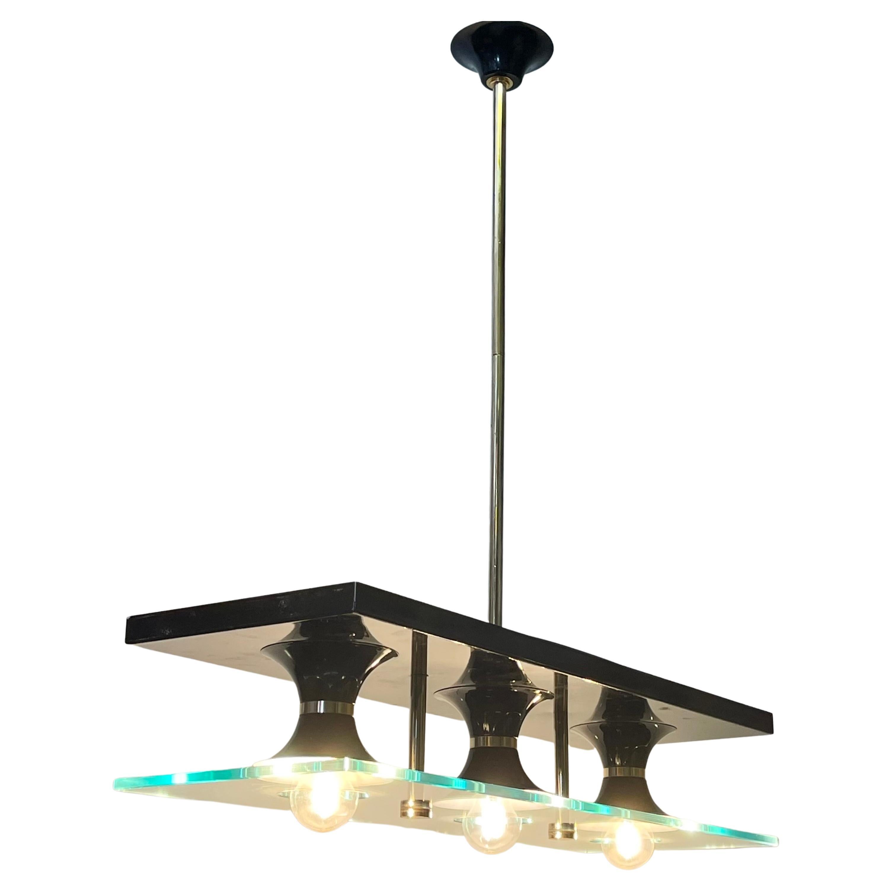 A mid - century modern glass, brass and black lacquered metal chandelier attr. to Stilnovo, Italy, circa 1950s.
Socket: 3 x E27 ( E26 for US) for standard screw bulbs.

 
 