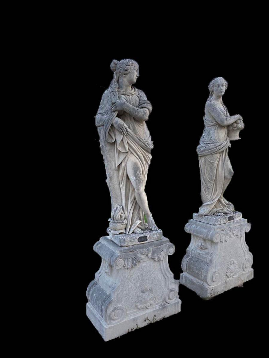 Set of amazing Italian stone statues with standing classically draped female figures and their distinguishing symbols. Autumn, winter, spring and summer. Measures: Height cm 175 with square form bases cm H 80 x W 65 x 52.