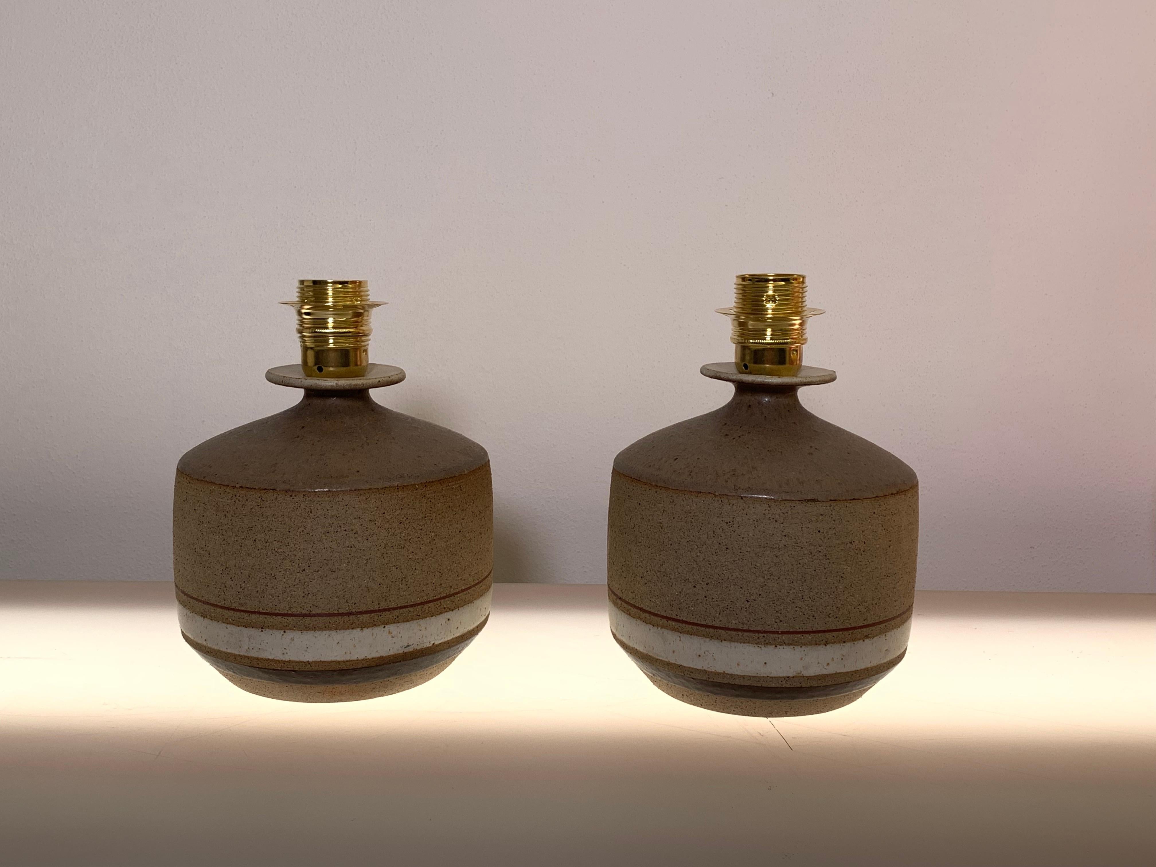 Two bases of stoneware lamps designed by the famous Italian artist Bruno Gambone. Signed on the bottom.