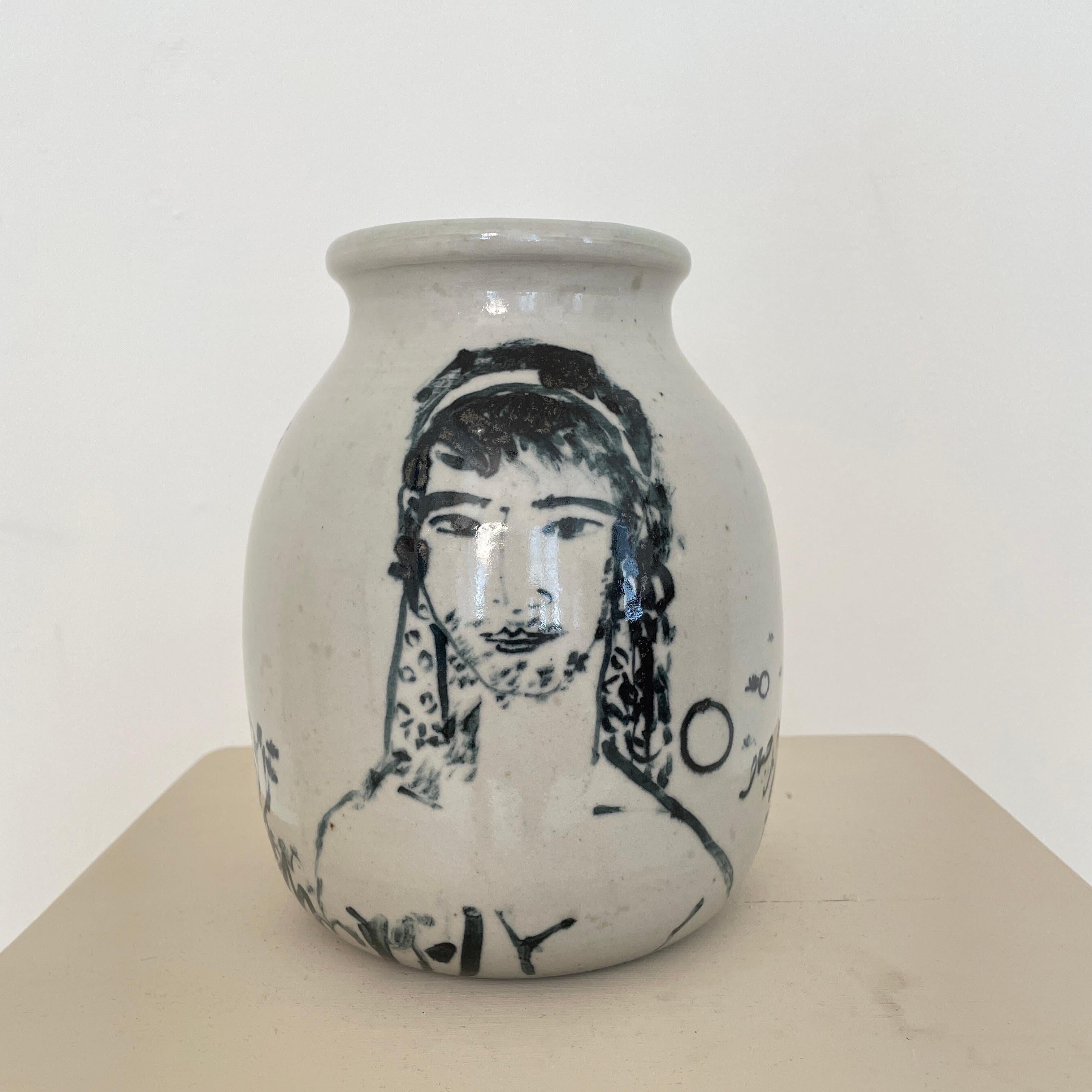 This beautiful Italian stoneware vase was hand painted and finally glazed. It was made around 1970.
You can see in black on a gray background a woman's and a man's head, next to some floral decorations.
A unique piece which is a great eye-catcher