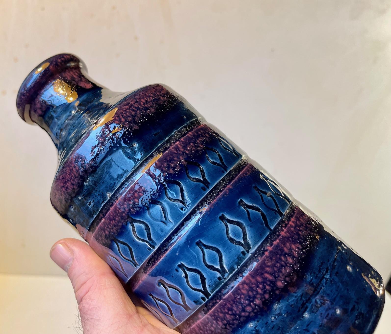 A rare vase in chamotte clay. Executed in high-gloss blue and purple glazes and featuring a center pattern of hand-incised water drops or onions. It was manufactured in Italy by Bitossi during the late 1960s. It is numbered and marked AROL to its