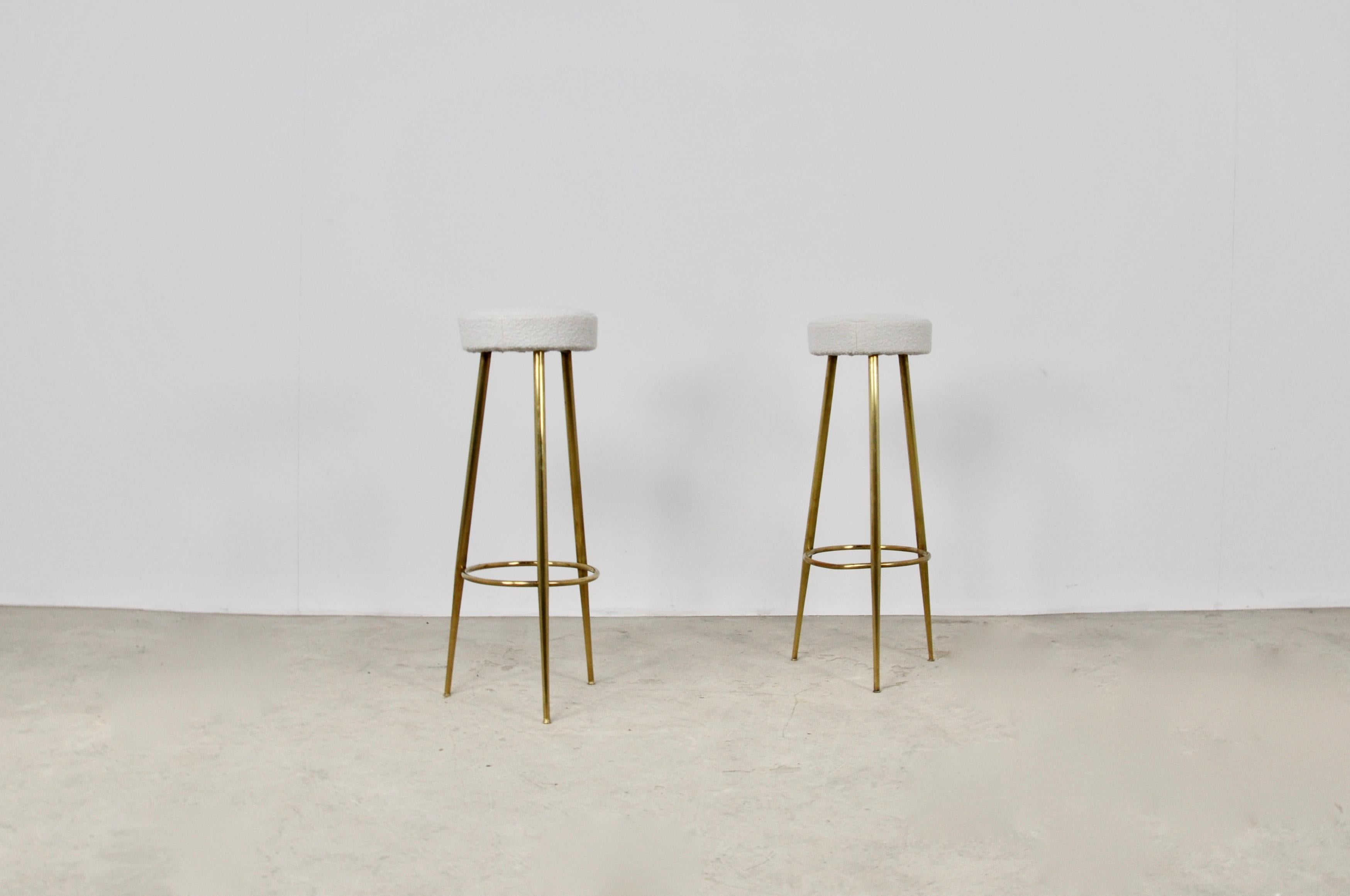 Pair of stool in brass and white fabric. Wear due to time and age of stools.
