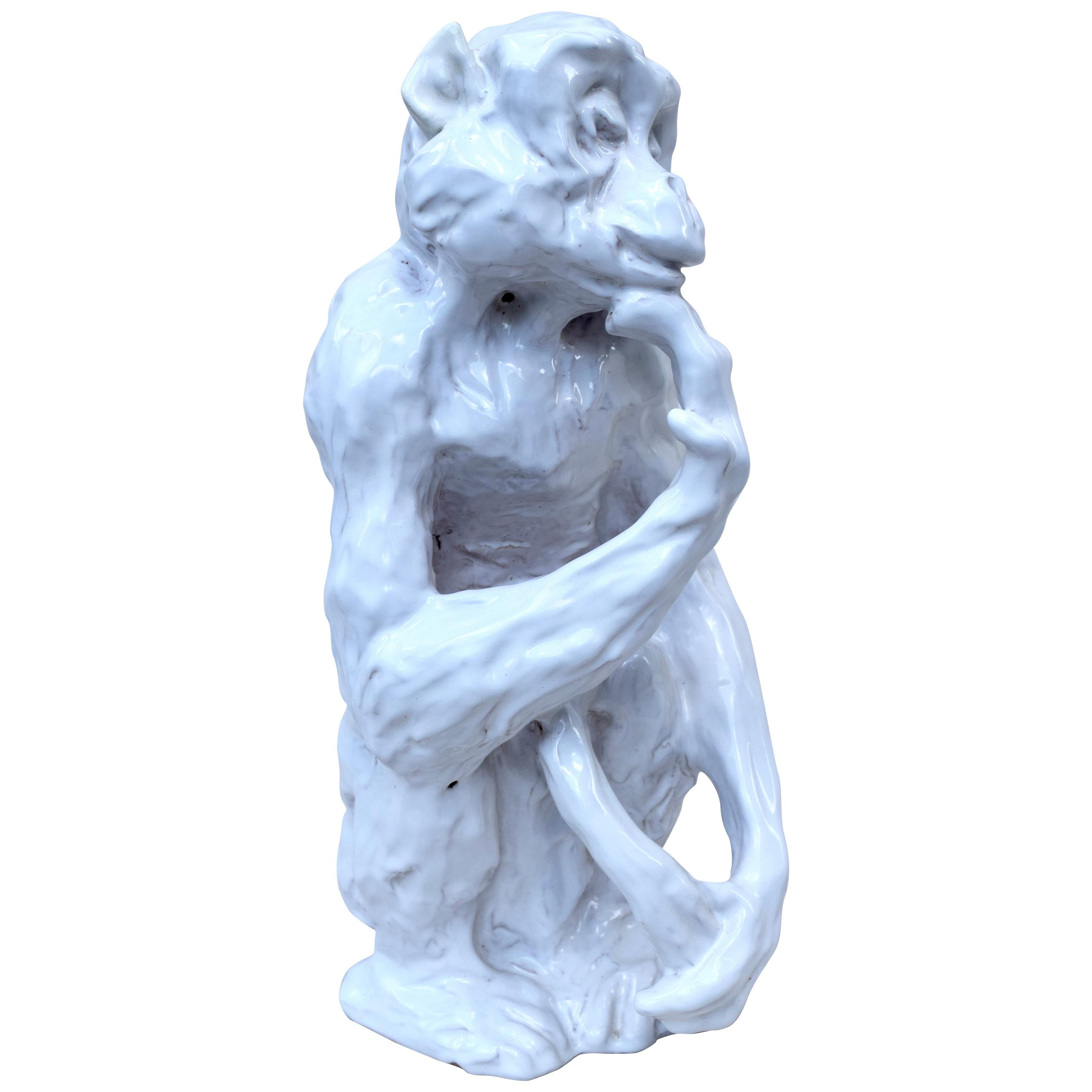 A delightful hand-sculpted and glazed Hollywood Regency style sitting Monkey in a contemplative pose. Mid-Century Modern period, made in Italy and signed.