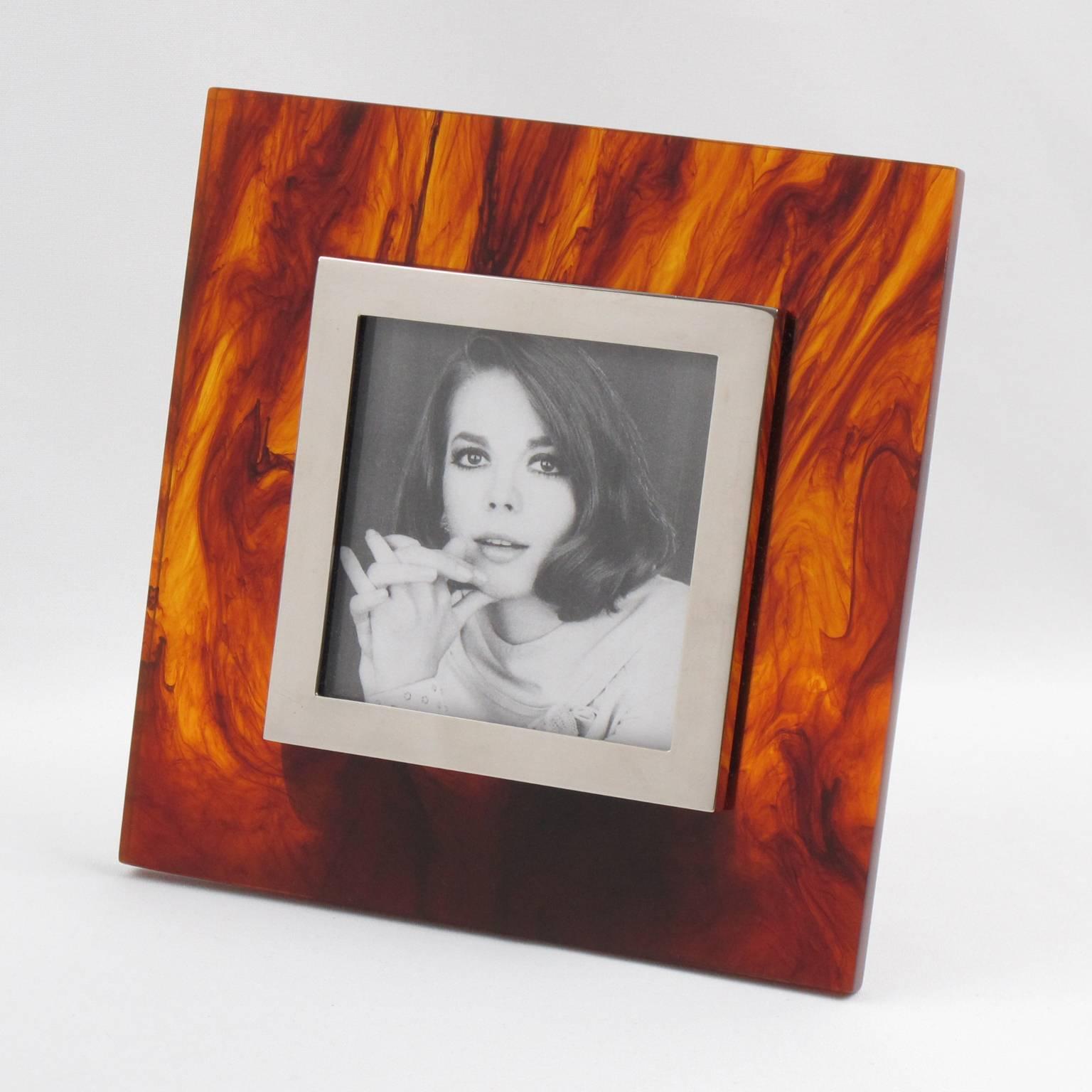 1970s modernist picture photo frame designed by Silva Studio, Italy. Thick Lucite slab in tortoiseshell pattern with chromed metal framing and easel. Elegant geometric shape. 
Measurements:
Overall: 7.07 in. wide (18 cm) x 7.07 in. high (18 cm) x