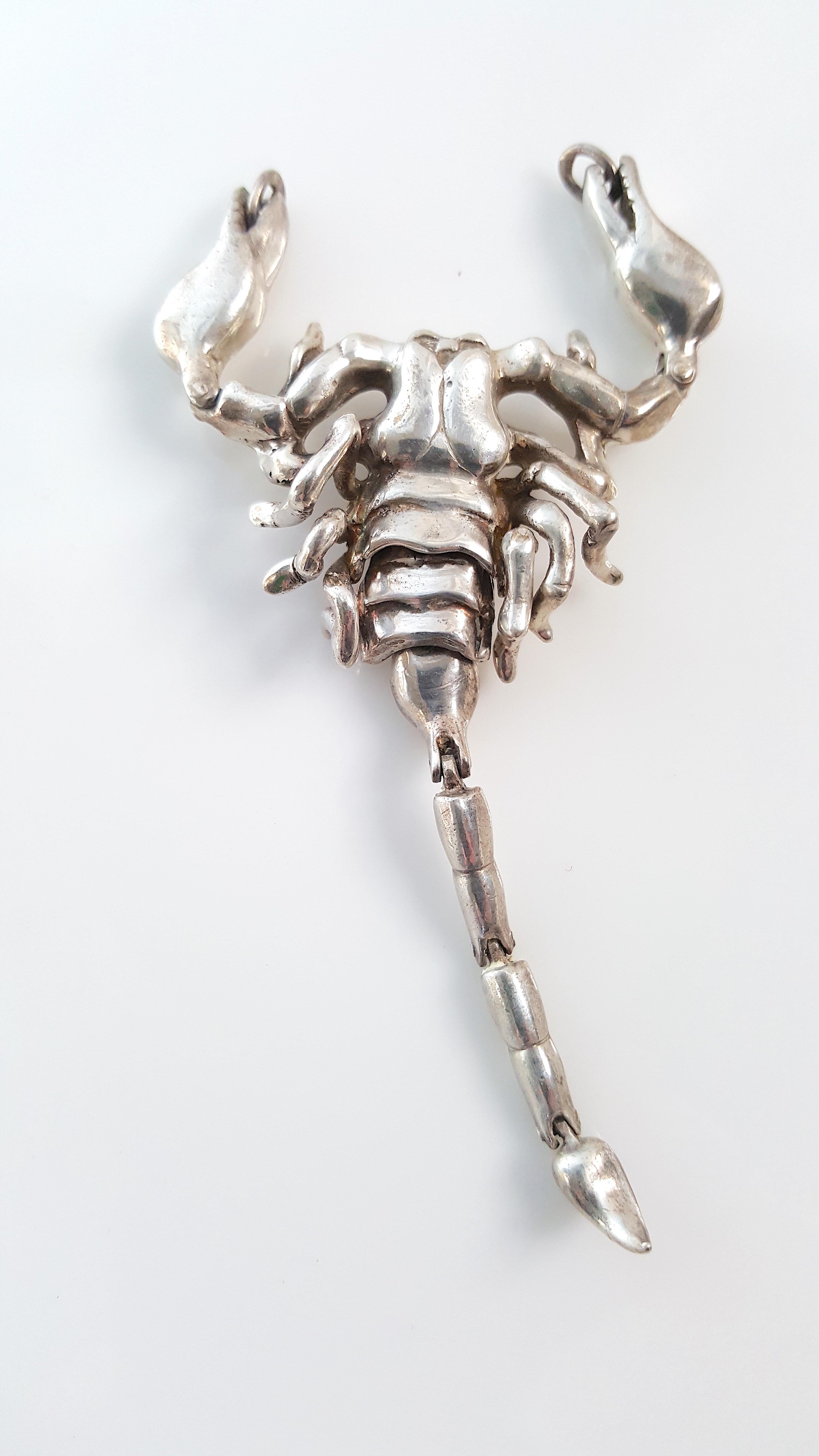 Italian-Riviera goldsmith Ugo Cacciatori, while he worked from his coastal studio on the Cinque Terra, designed this signed one-of-a-kind kinetic zodiac scorpion sterling-silver pendant in 2002. During the early 2000s, he was creating runway pieces