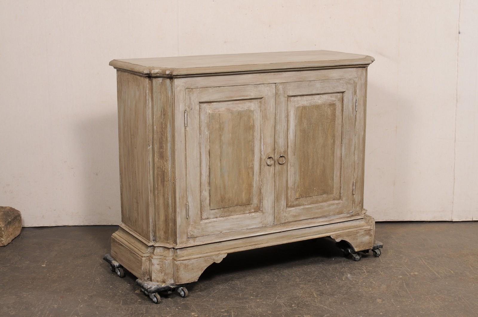 An Italian inspired, American made carved wood, two-door buffet cabinet. This vintage console cabinet has been beautifully designed with Italian influences, and created out of old, reclaimed wood. It has a rectangular-shape with nicely-carved and