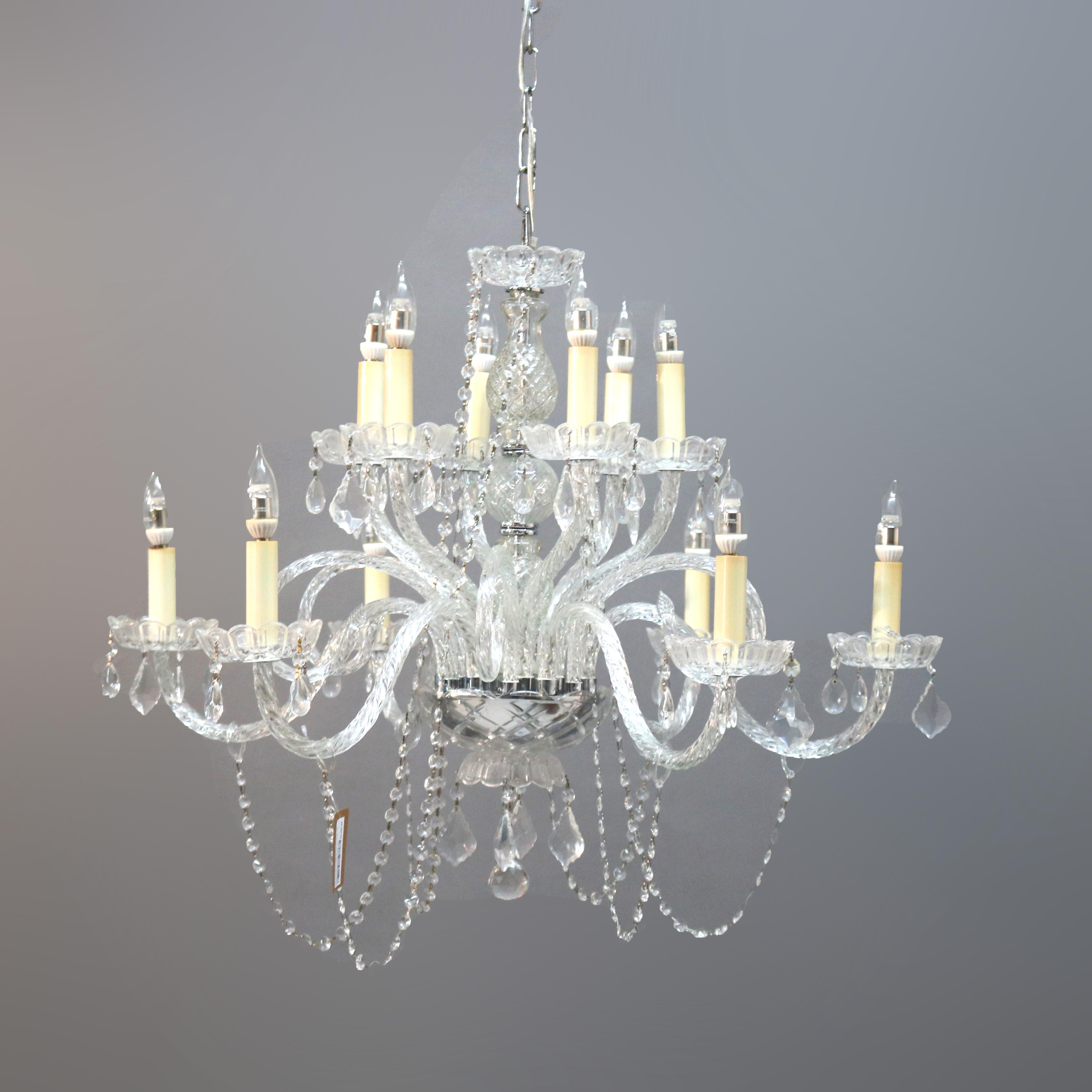 An Italian style chandelier offers a chrome frame in tiered form with twelve scroll form arms terminating in candle lights, cut and strung crystals throughout, 20th century

Measures - 55''h x 32''w x 32''d; 30'' drop.

Catalogue Note: Ask about